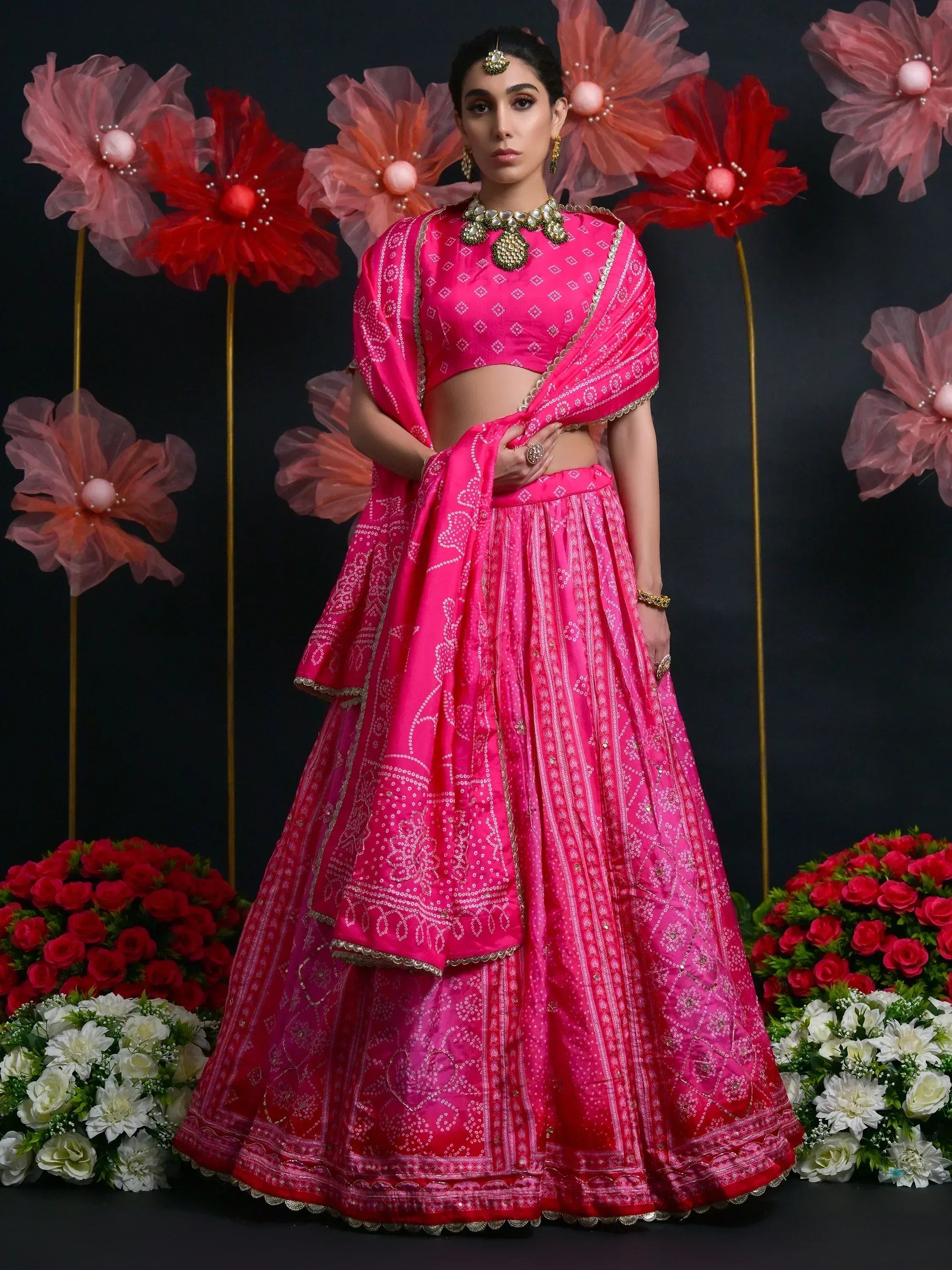 Vibrant pink lehenga choli with gold embroidery, perfect for Indian weddings and festive occasions.