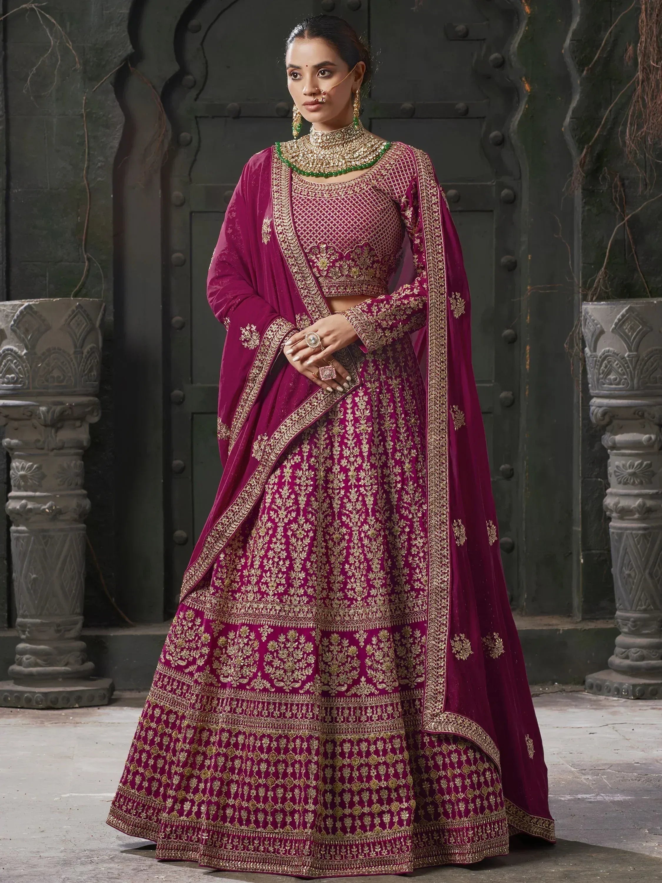 Elegant maroon lehenga choli with gold embroidery, perfect for Indian weddings and festive occasions.