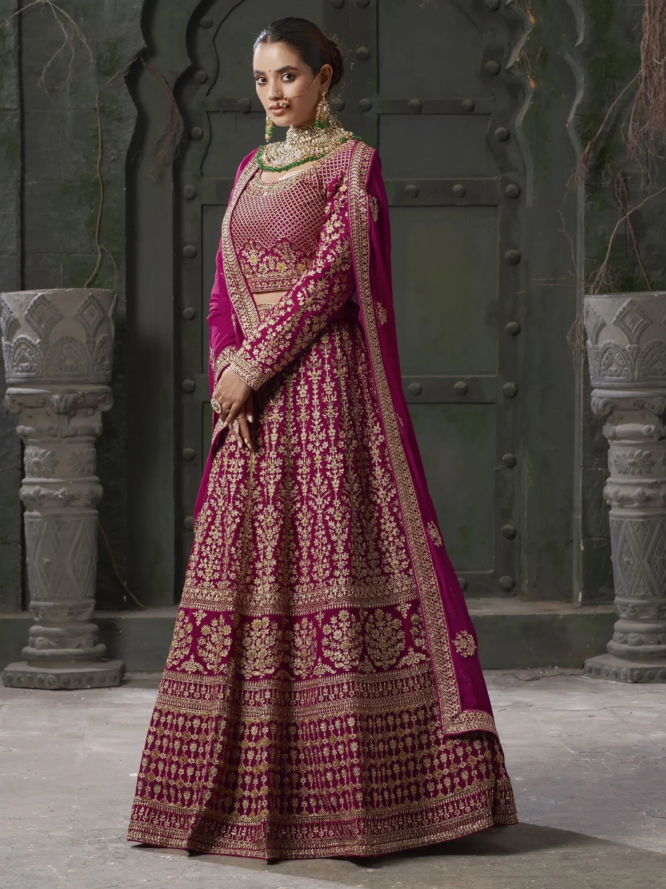 Elegant maroon lehenga choli with gold embroidery, perfect for Indian weddings and festive occasions.