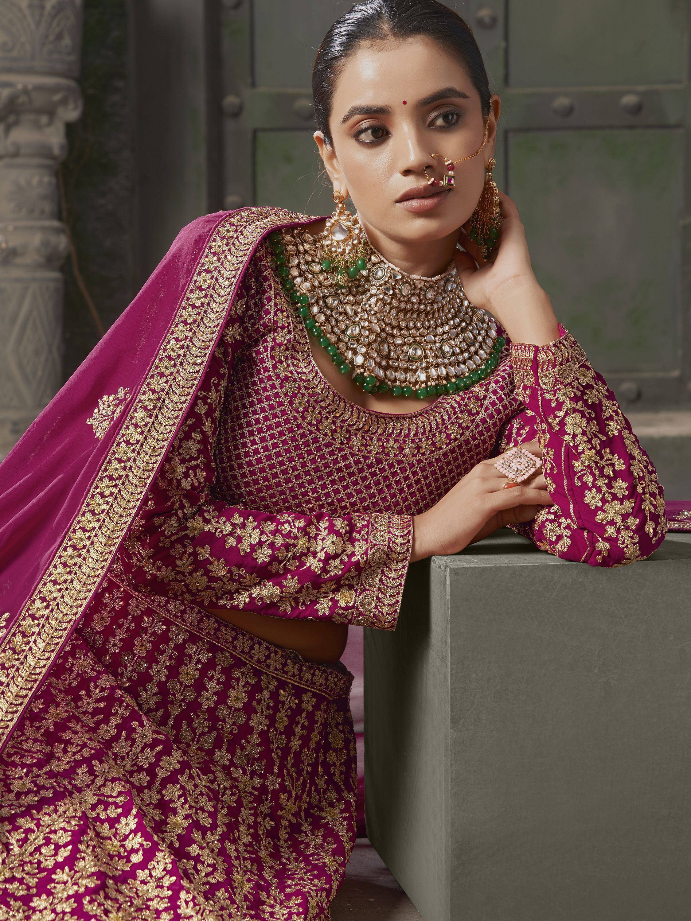 Elegant maroon lehenga choli with gold embroidery, perfect for Indian weddings and festive occasions.