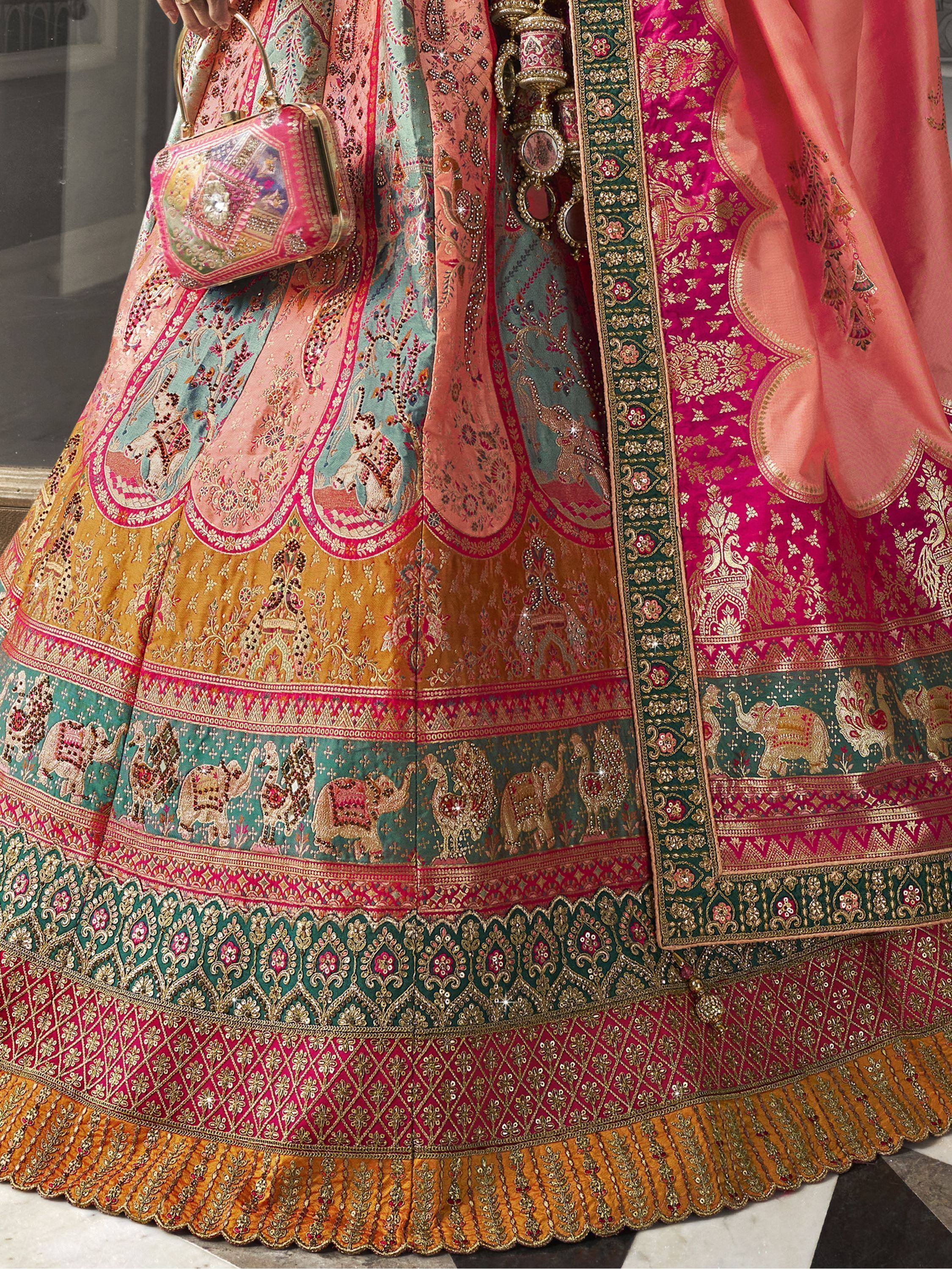 Designer lehenga choli with intricate elephant motifs, zari work, and matching embroidered clutch for Indian ethnic wear.
