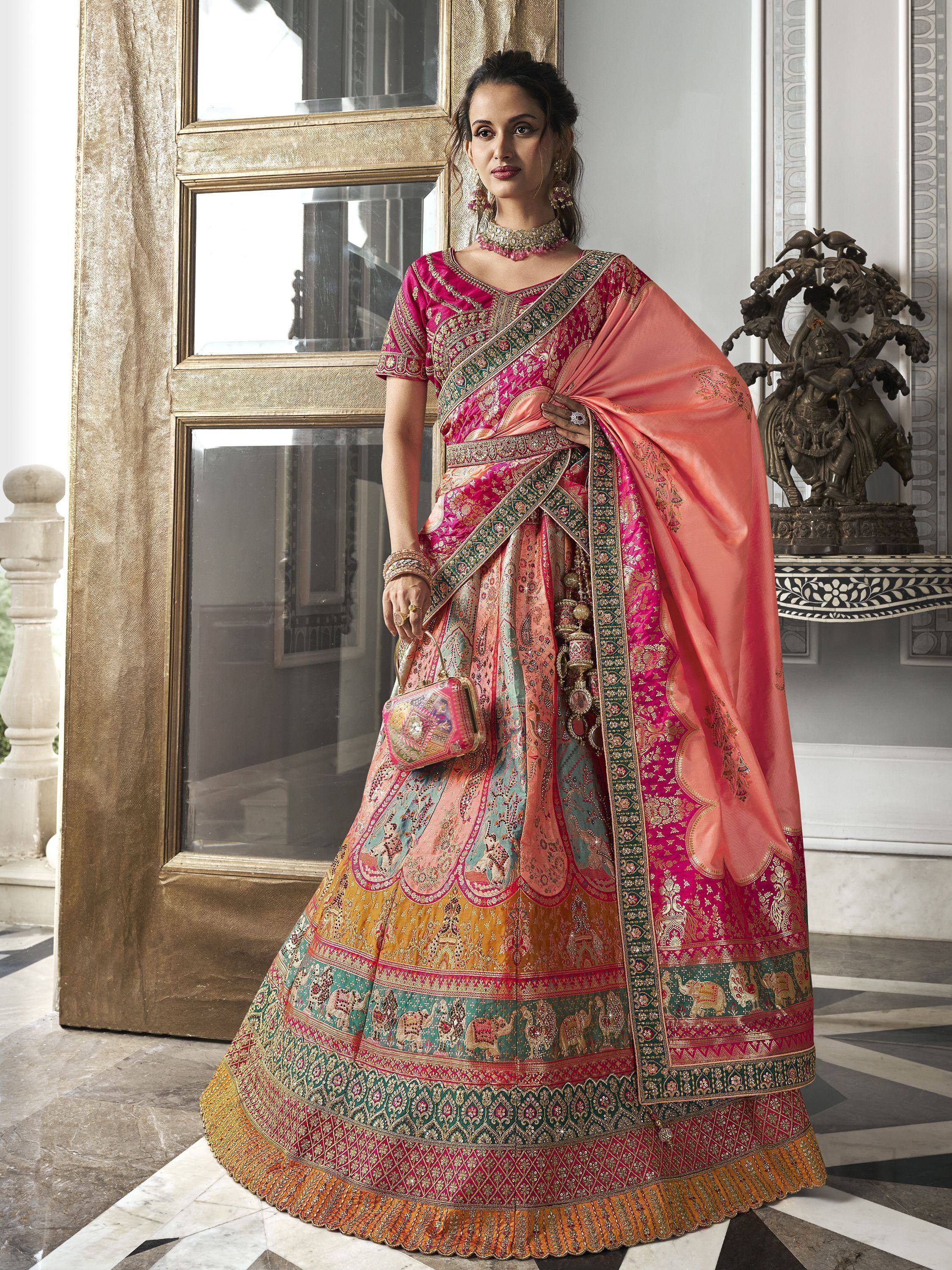 Elegant pink and gold designer lehenga choli with intricate embroidery and elephant motifs, perfect for Indian weddings.