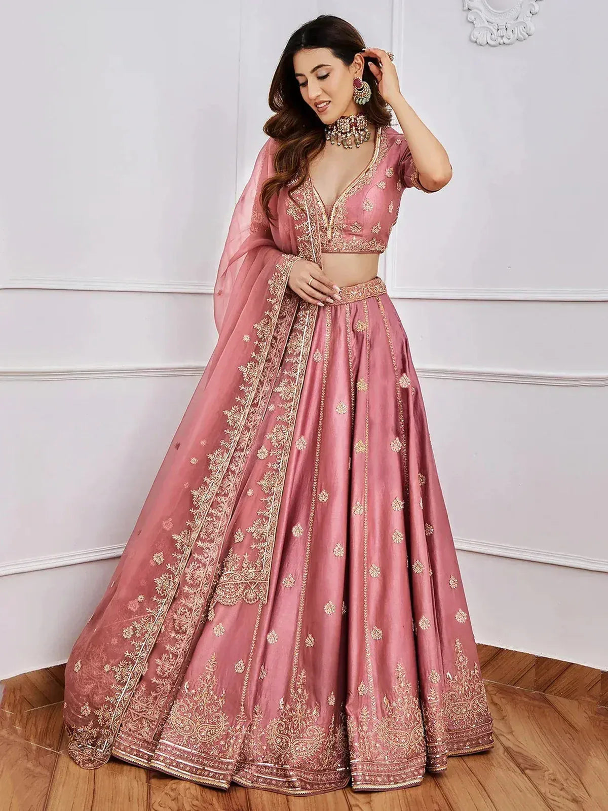 Pink designer lehenga choli with gold embroidery, perfect for Indian weddings and festive occasions
