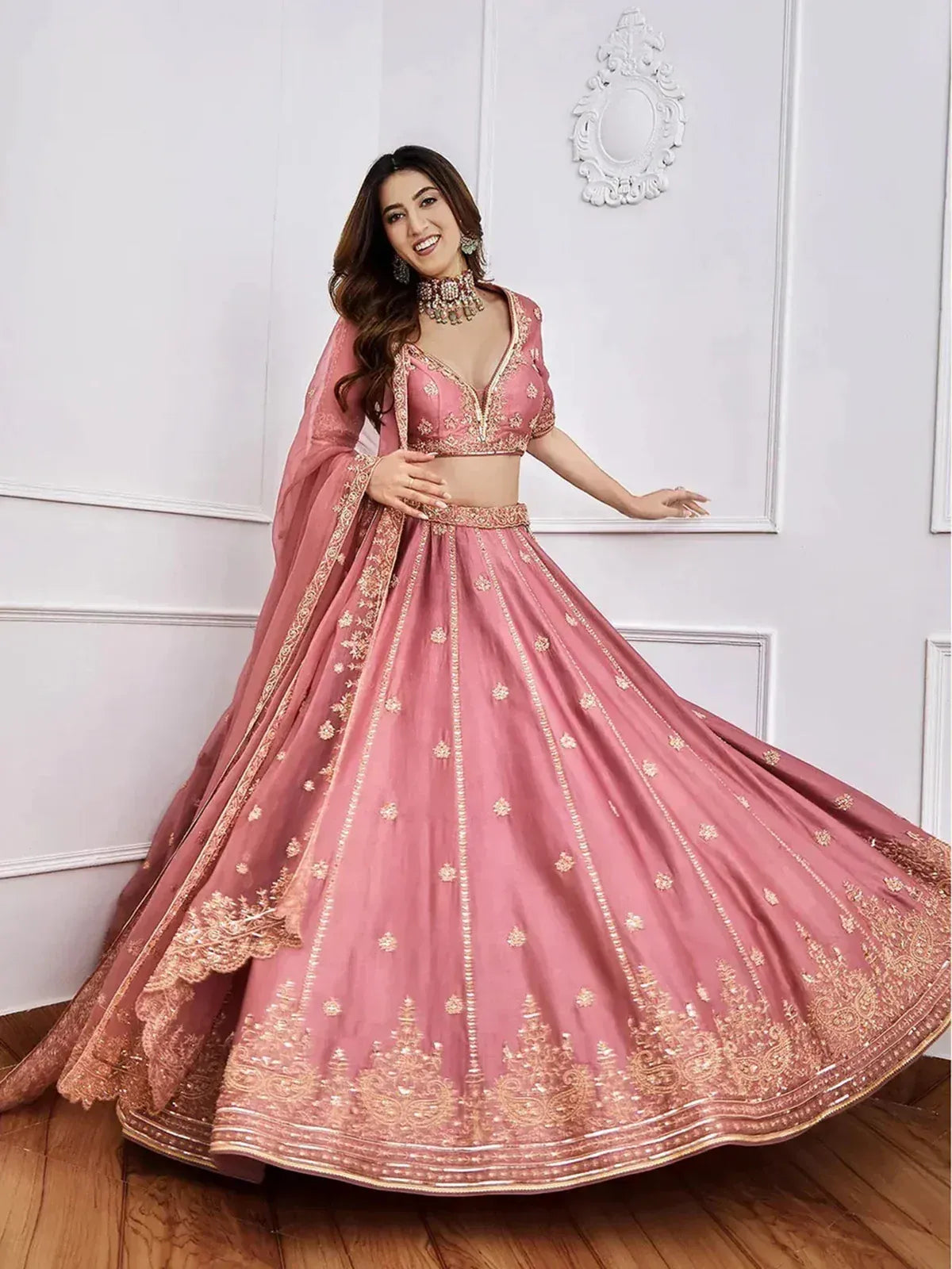 Pink designer lehenga choli with gold embroidery, perfect for weddings and festive occasions