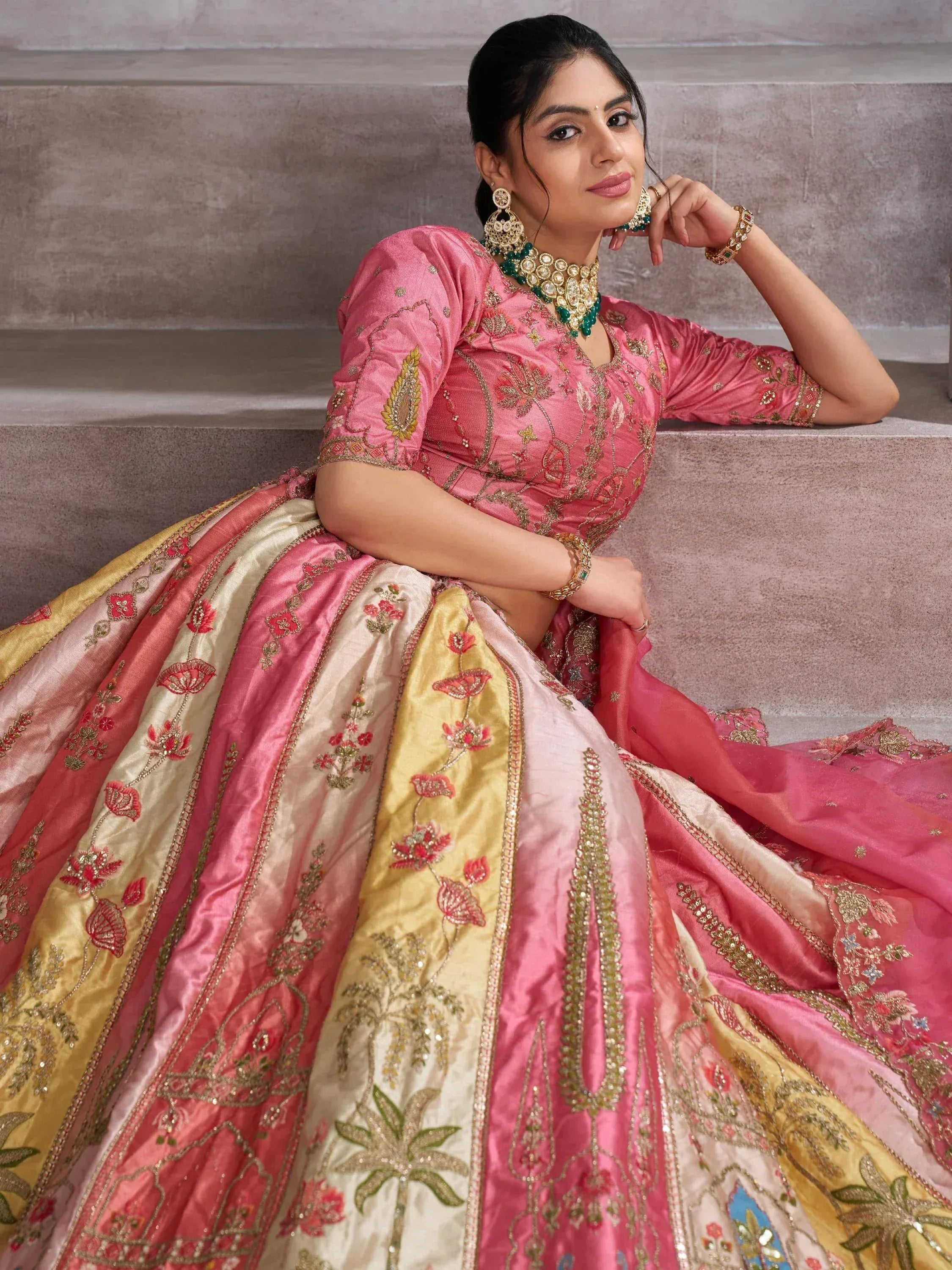 Pink and gold embroidered lehenga choli with floral motifs, perfect for Indian ethnic wear occasions.