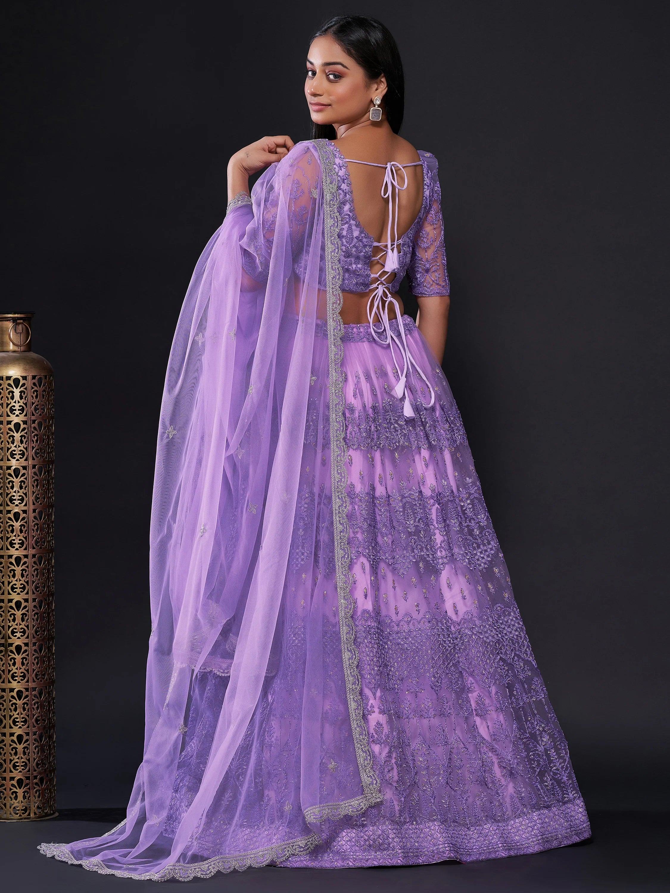 Lavender designer lehenga choli with lace-up back, sheer dupatta, and embroidered net skirt for Indian ethnic wear