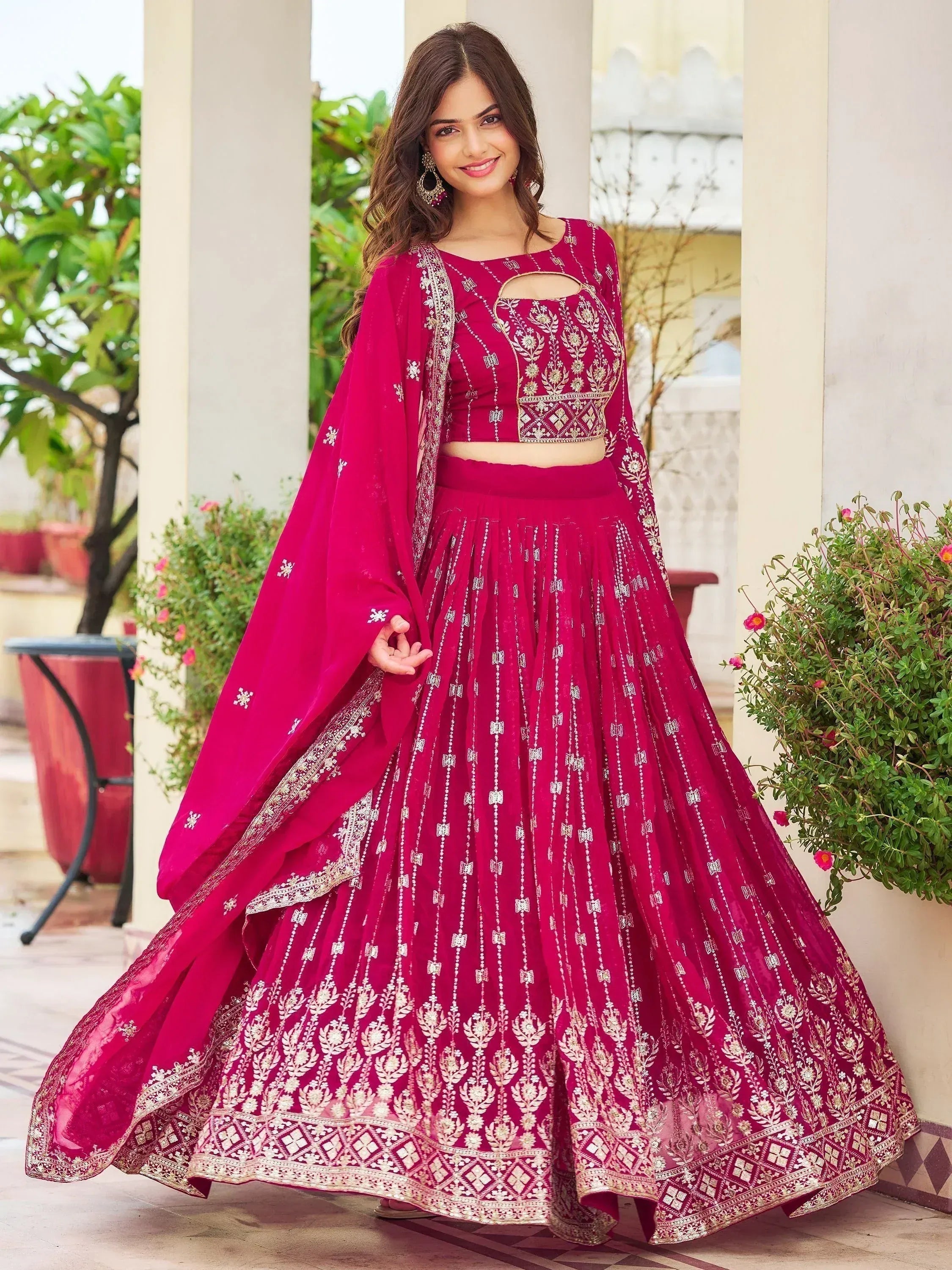 Elegant maroon lehenga choli with gold embroidery, perfect for Indian weddings and festive occasions.
