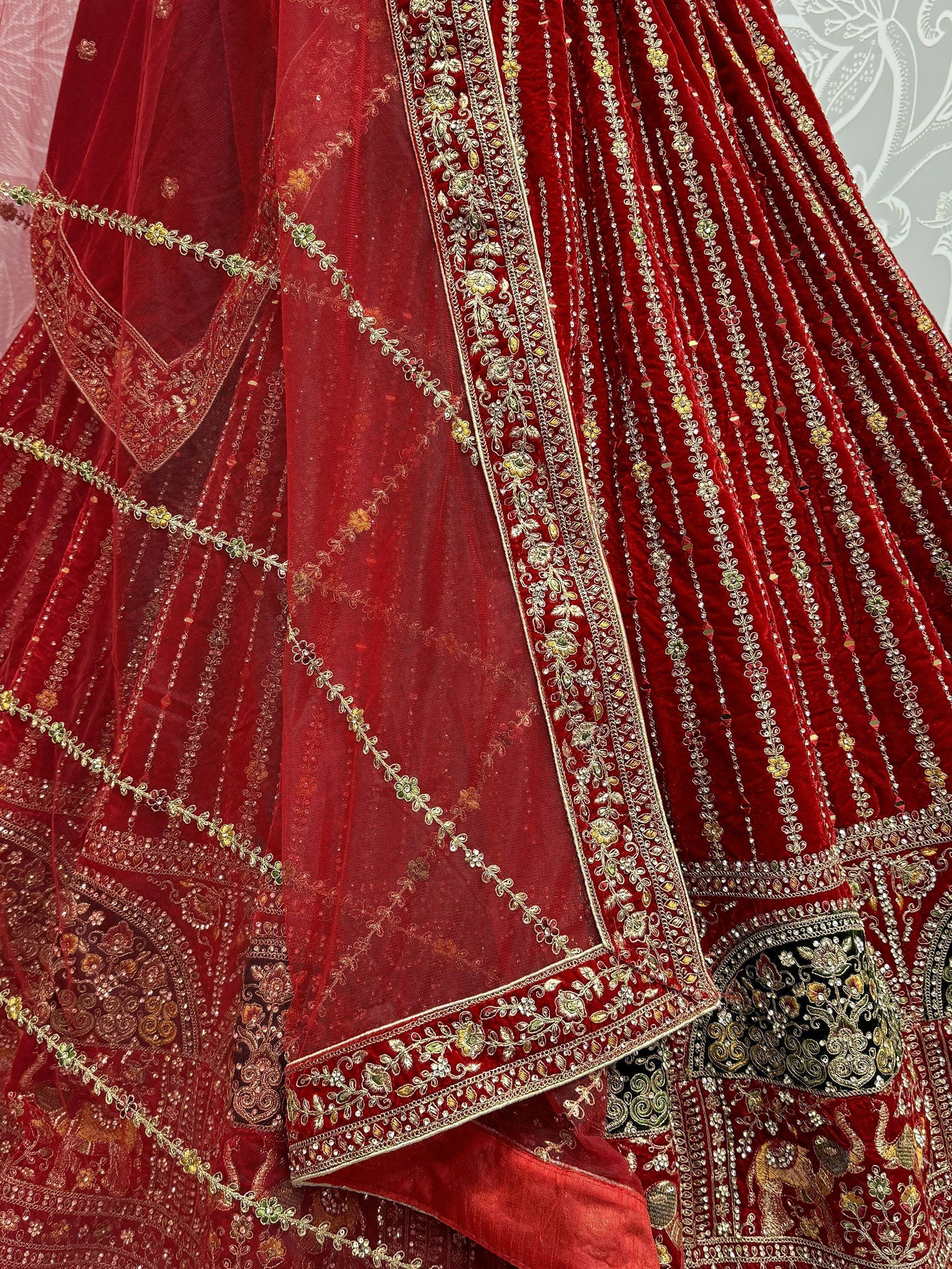 Red velvet lehenga with intricate gold embroidery and floral detailing