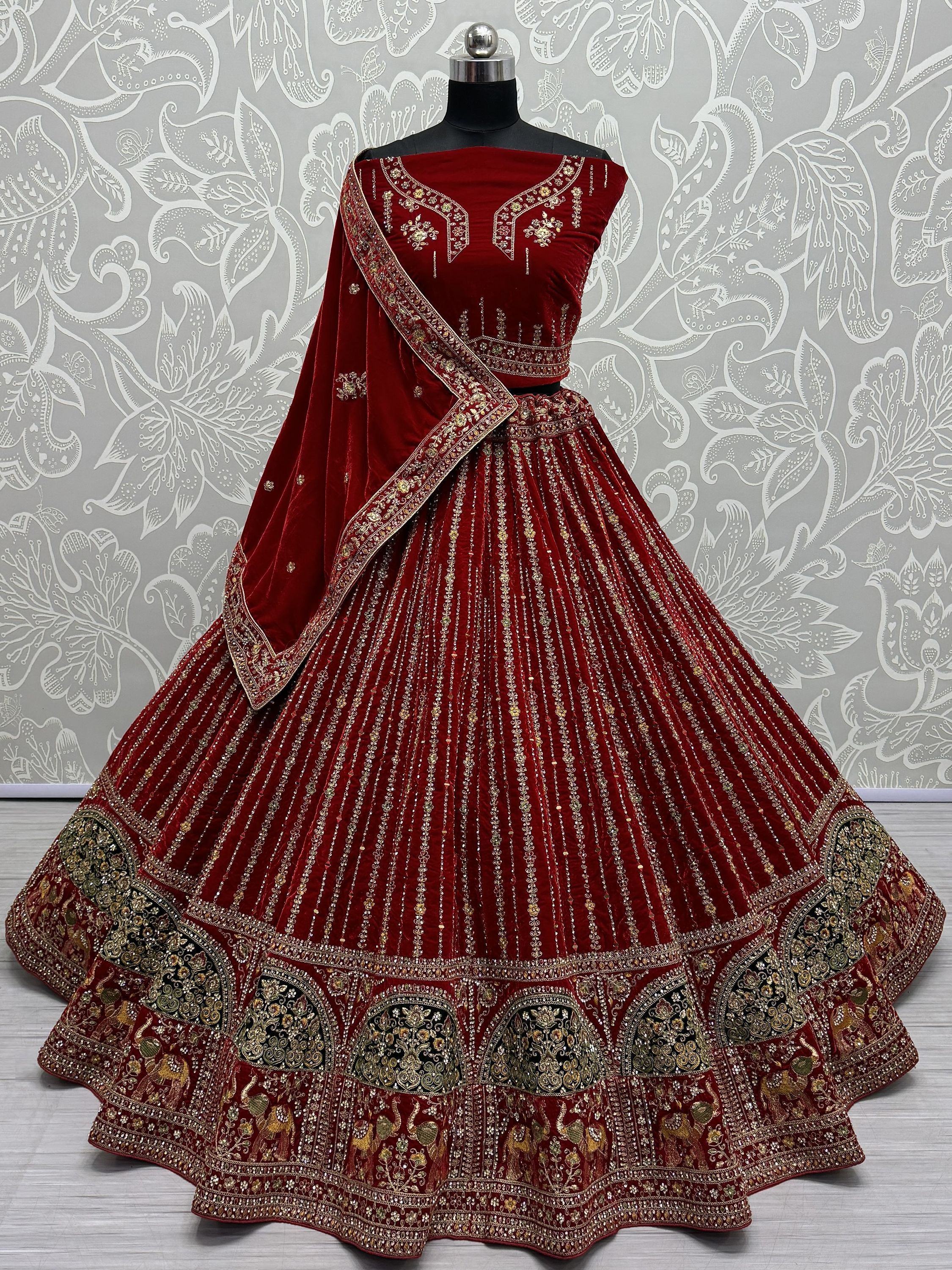 Luxury maroon velvet lehenga choli with gold embroidery and elephant motifs, perfect for Indian weddings