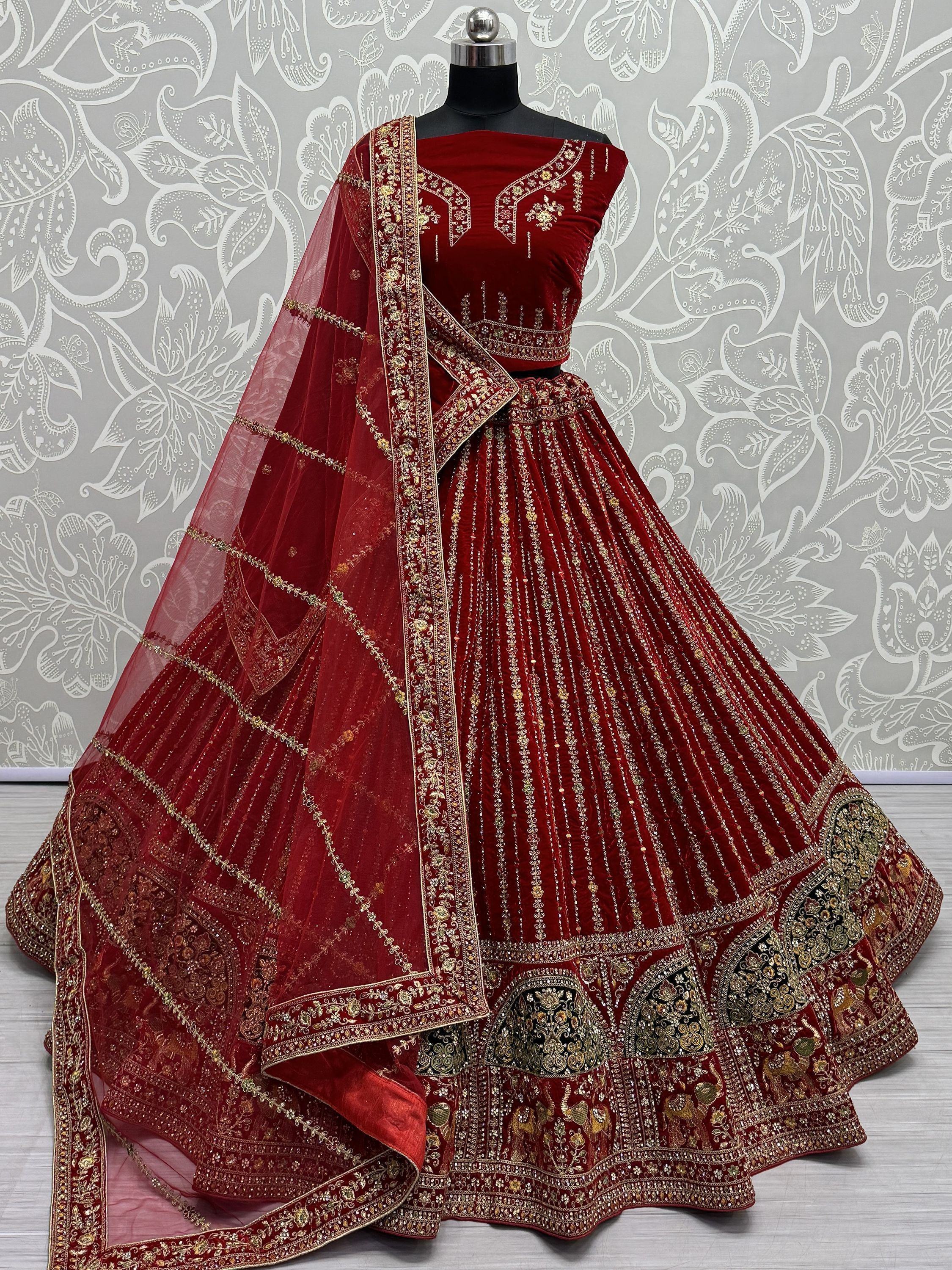 Red velvet designer lehenga choli with gold embroidery and sheer dupatta, ethnic Indian wear