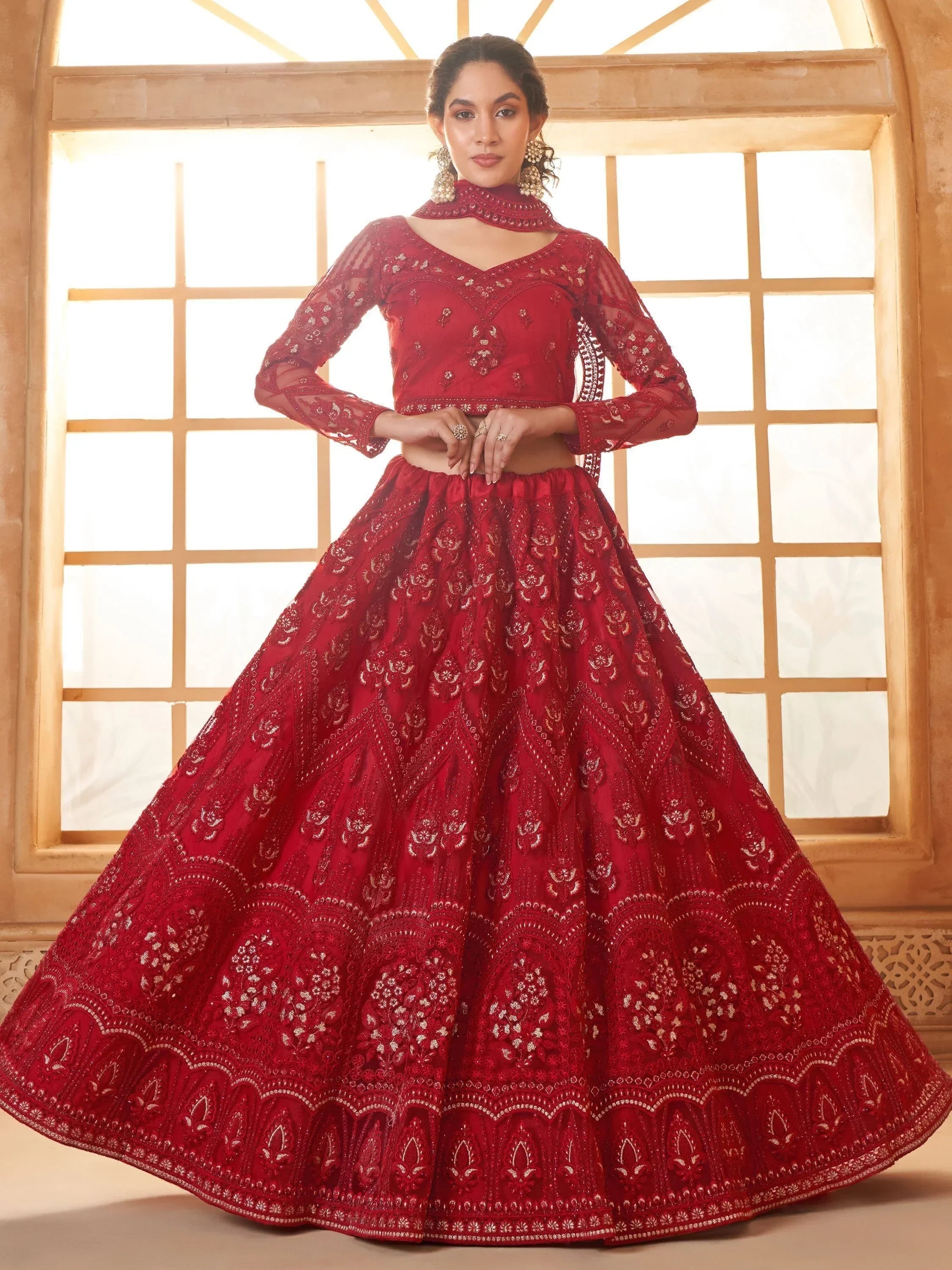 Red embroidered lehenga choli with sheer sleeves, perfect for Indian weddings and festive occasions