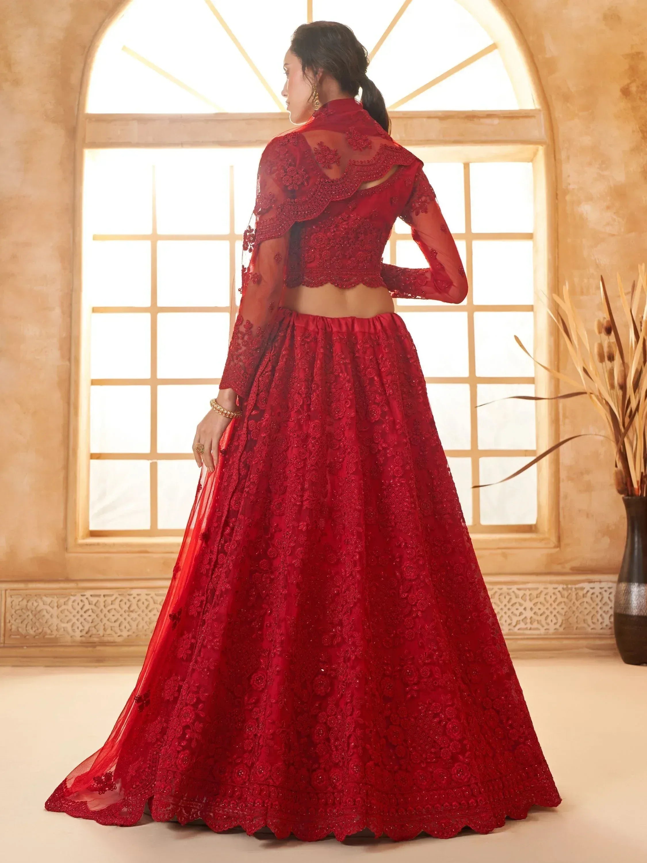 Red embroidered lehenga choli with sheer cape, perfect for Indian weddings and festive occasions
