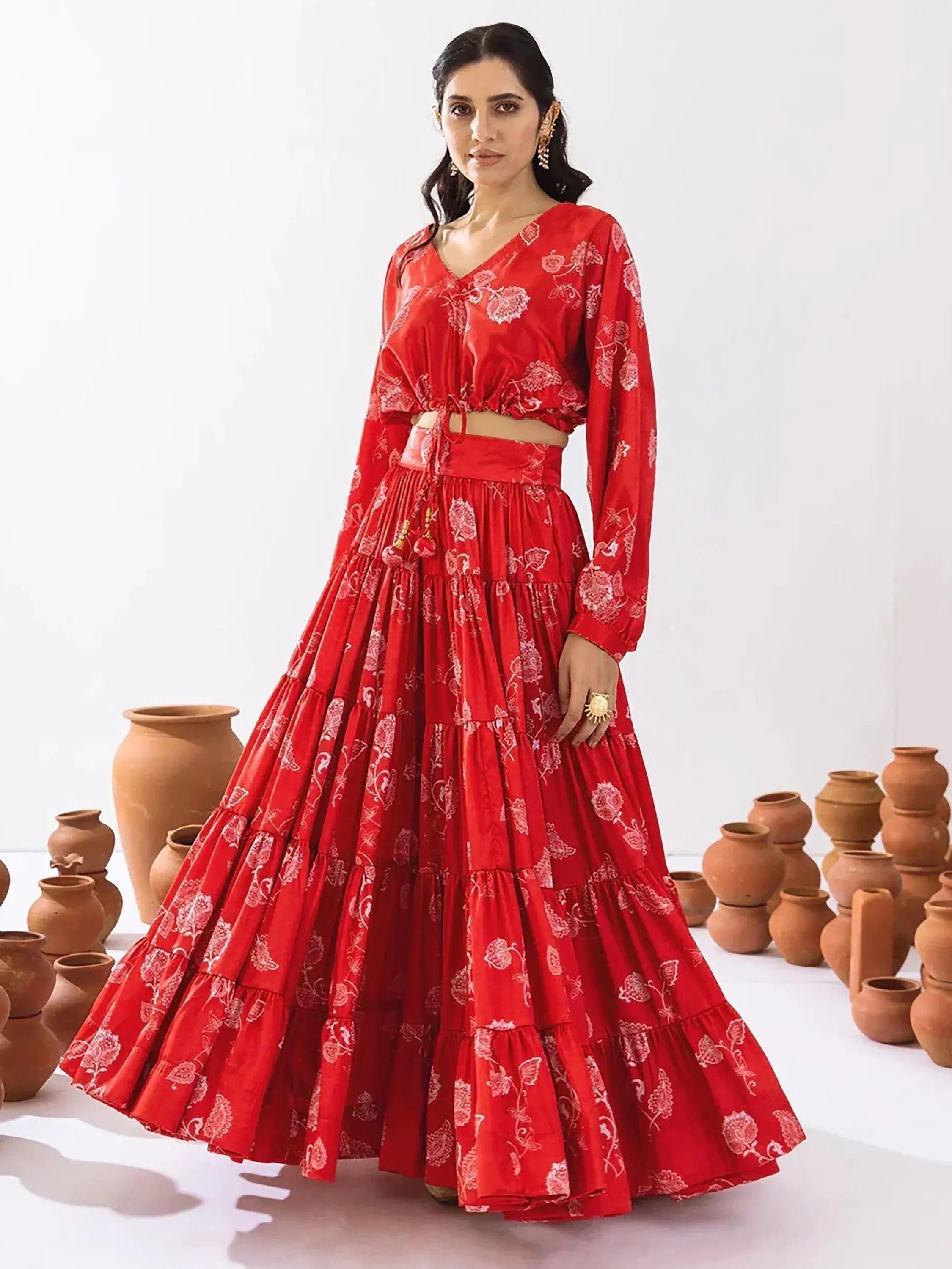 Red floral print ethnic lehenga choli with tiered skirt, perfect for Indian weddings and festive occasions
