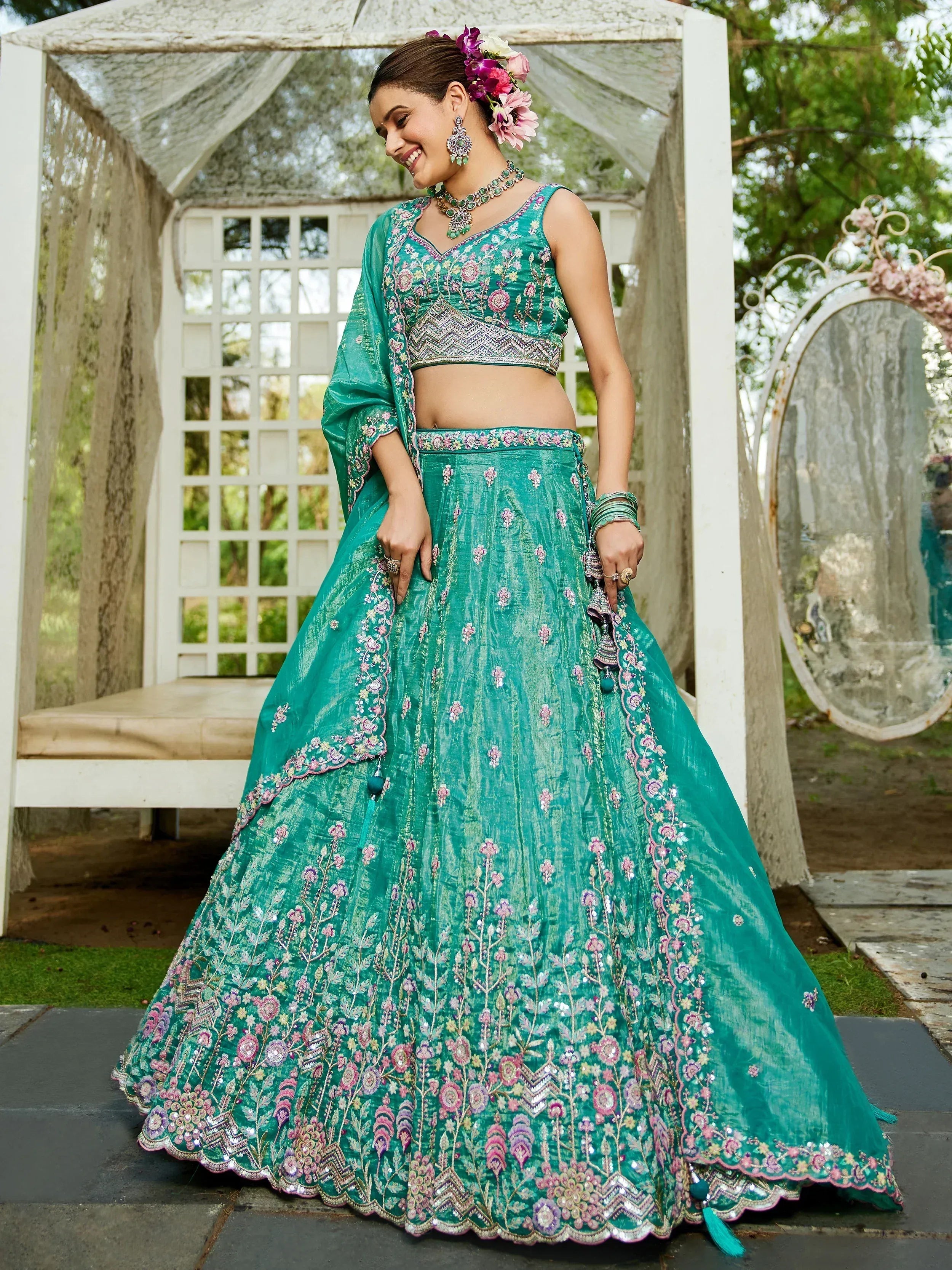 Teal embroidered lehenga choli with floral motifs, perfect for Indian weddings and festive occasions