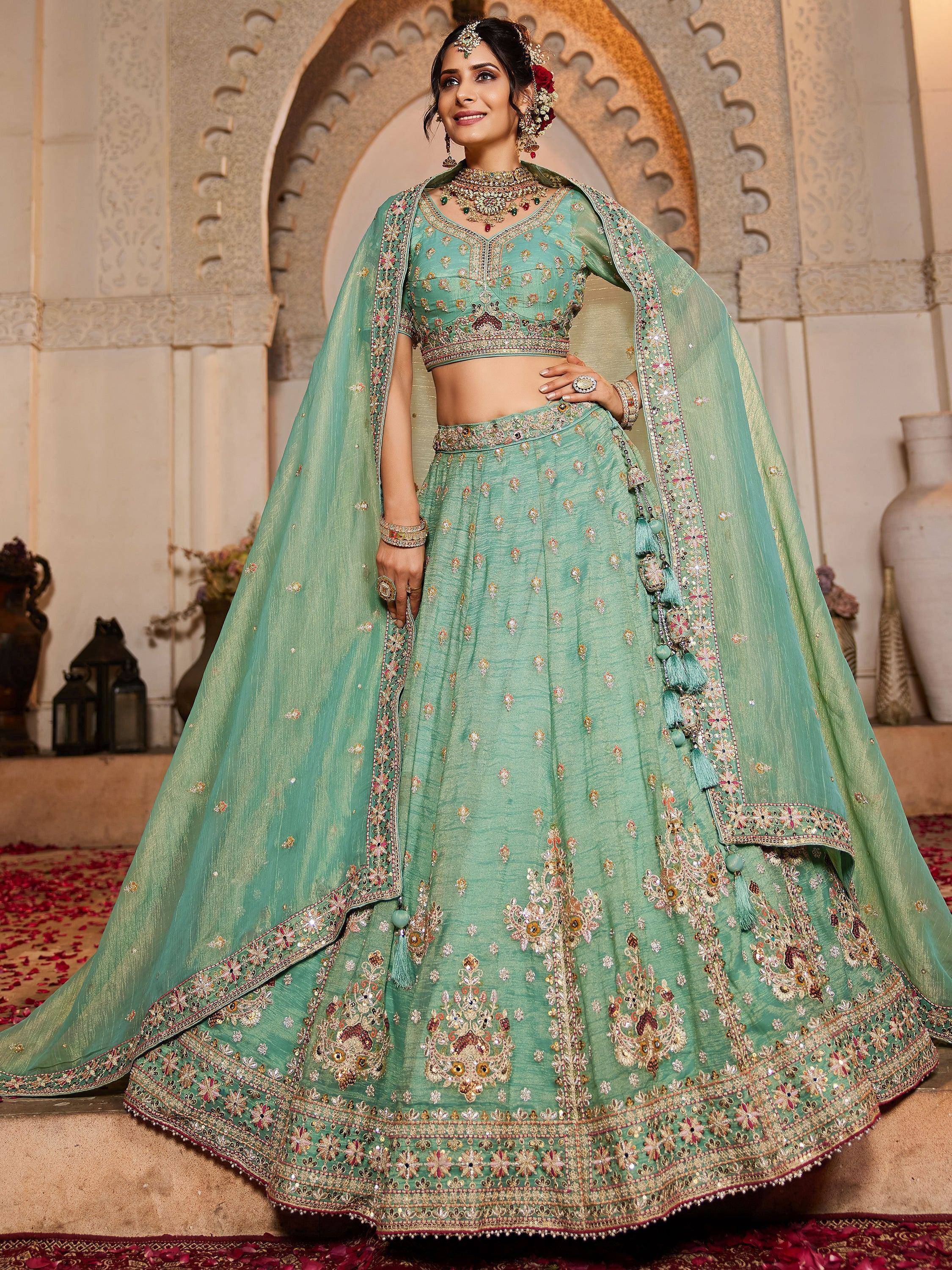 Mint green designer lehenga choli with heavy embroidery and dupatta, perfect for Indian weddings and festive occasions.