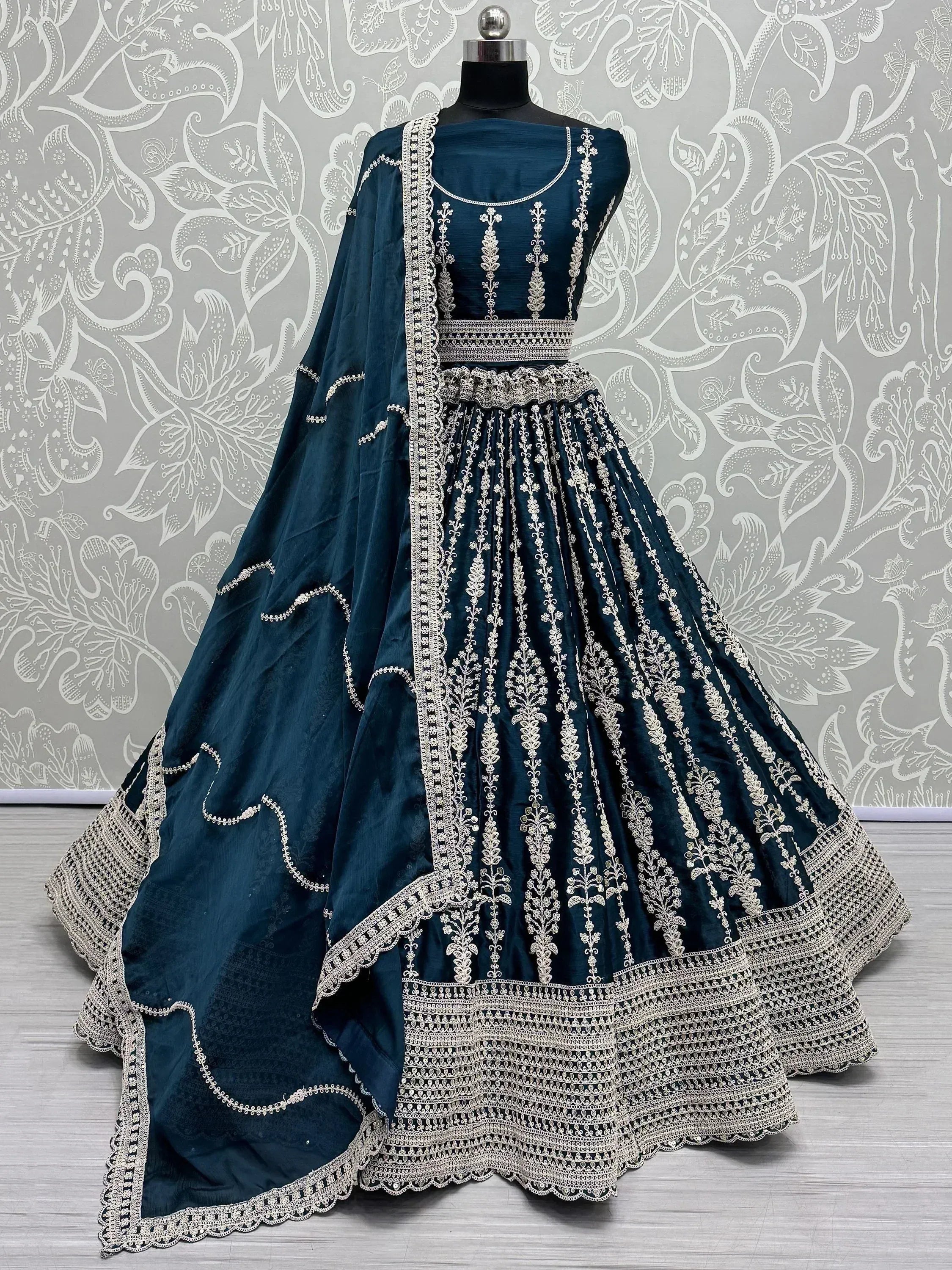 Teal designer lehenga choli with intricate silver embroidery and matching dupatta, perfect for Indian ethnic wear.