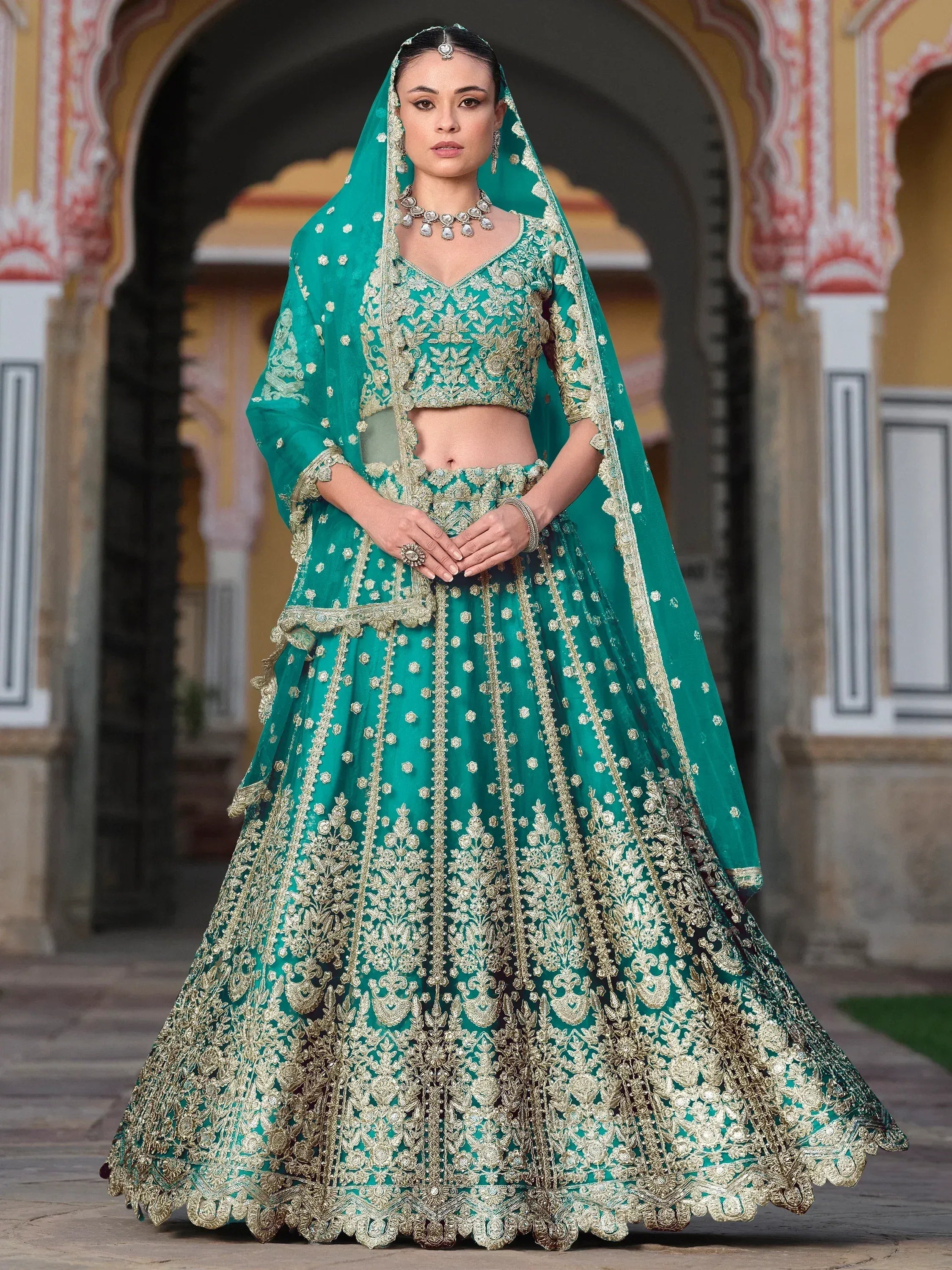 Emerald green designer lehenga choli with gold embroidery, perfect for Indian weddings and ethnic events.