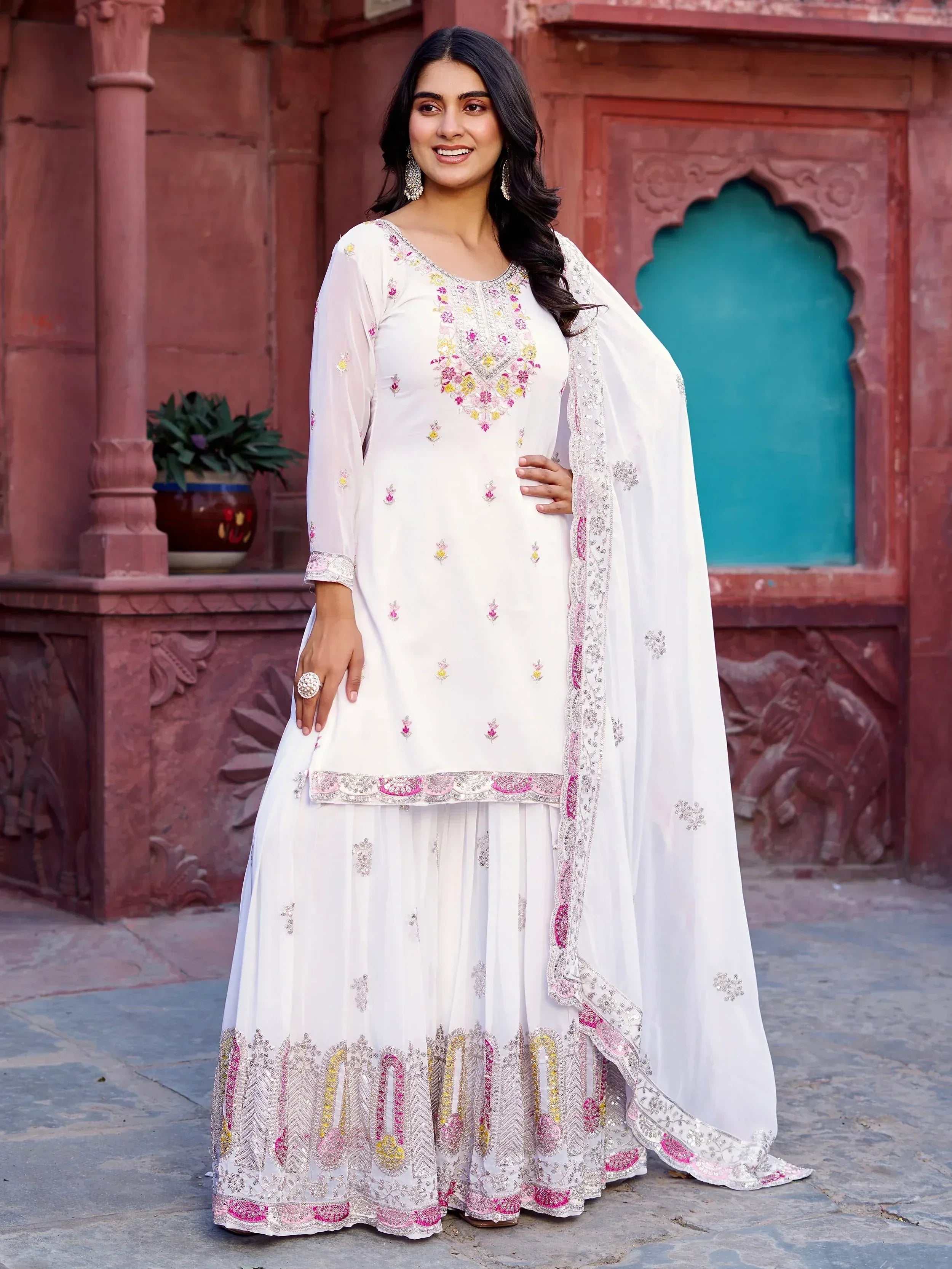 White embroidered salwar kameez with pink and gold detailing, perfect for Indian ethnic wear occasions.