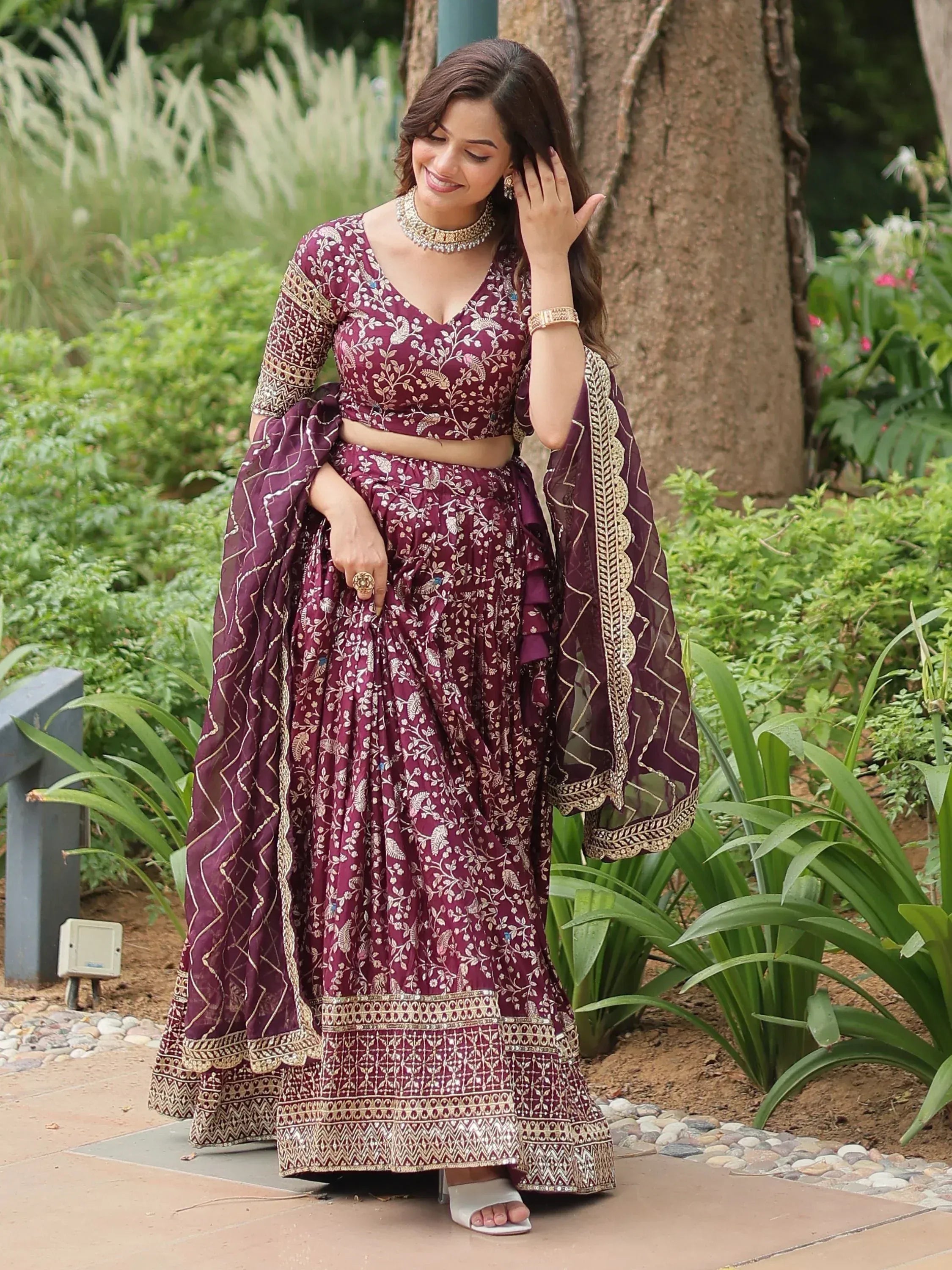 Elegant maroon lehenga choli with gold embroidery, perfect for Indian weddings and festive occasions.