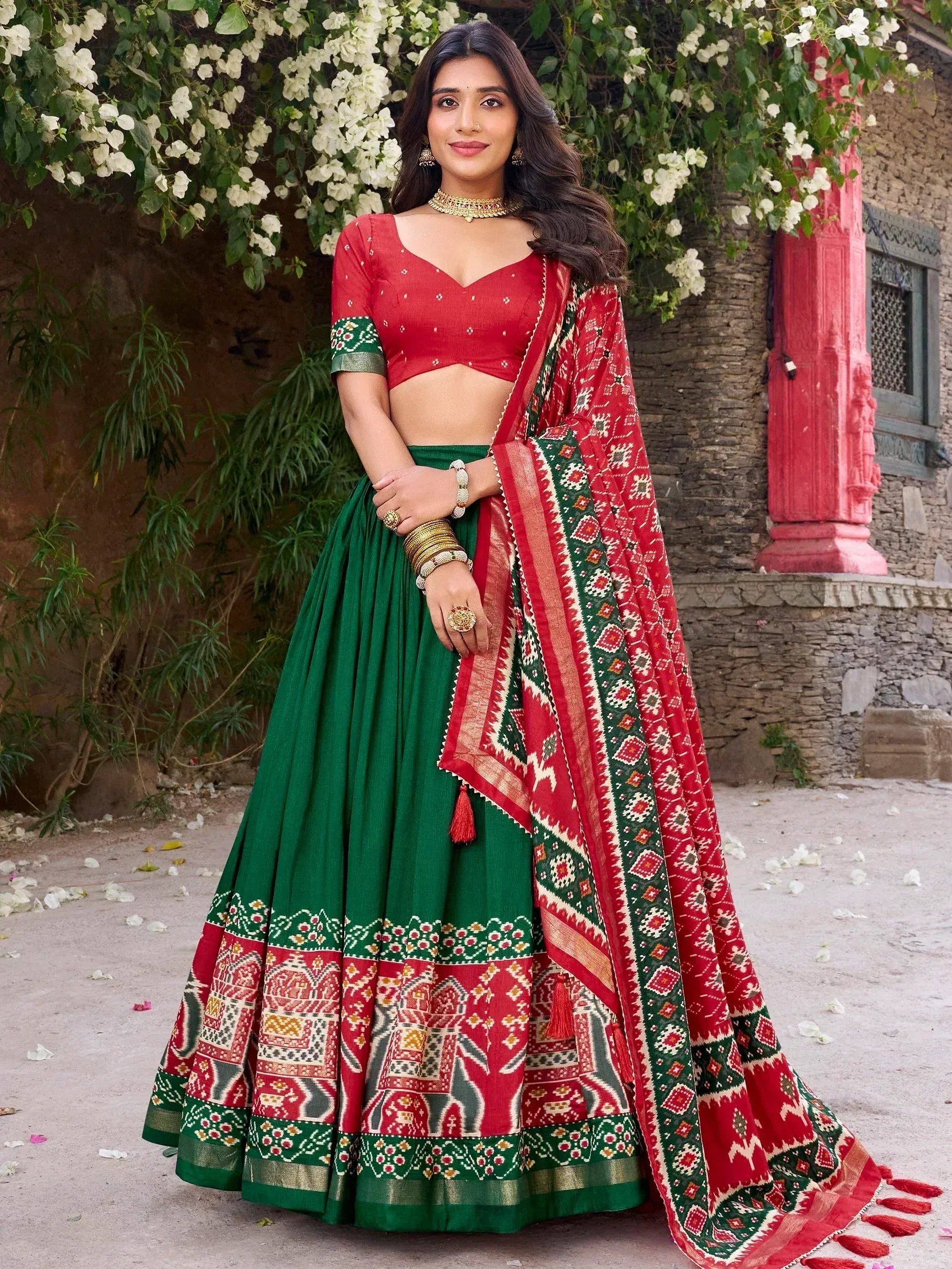 Red and green printed lehenga choli with ethnic patterns, perfect for Indian festive occasions and weddings