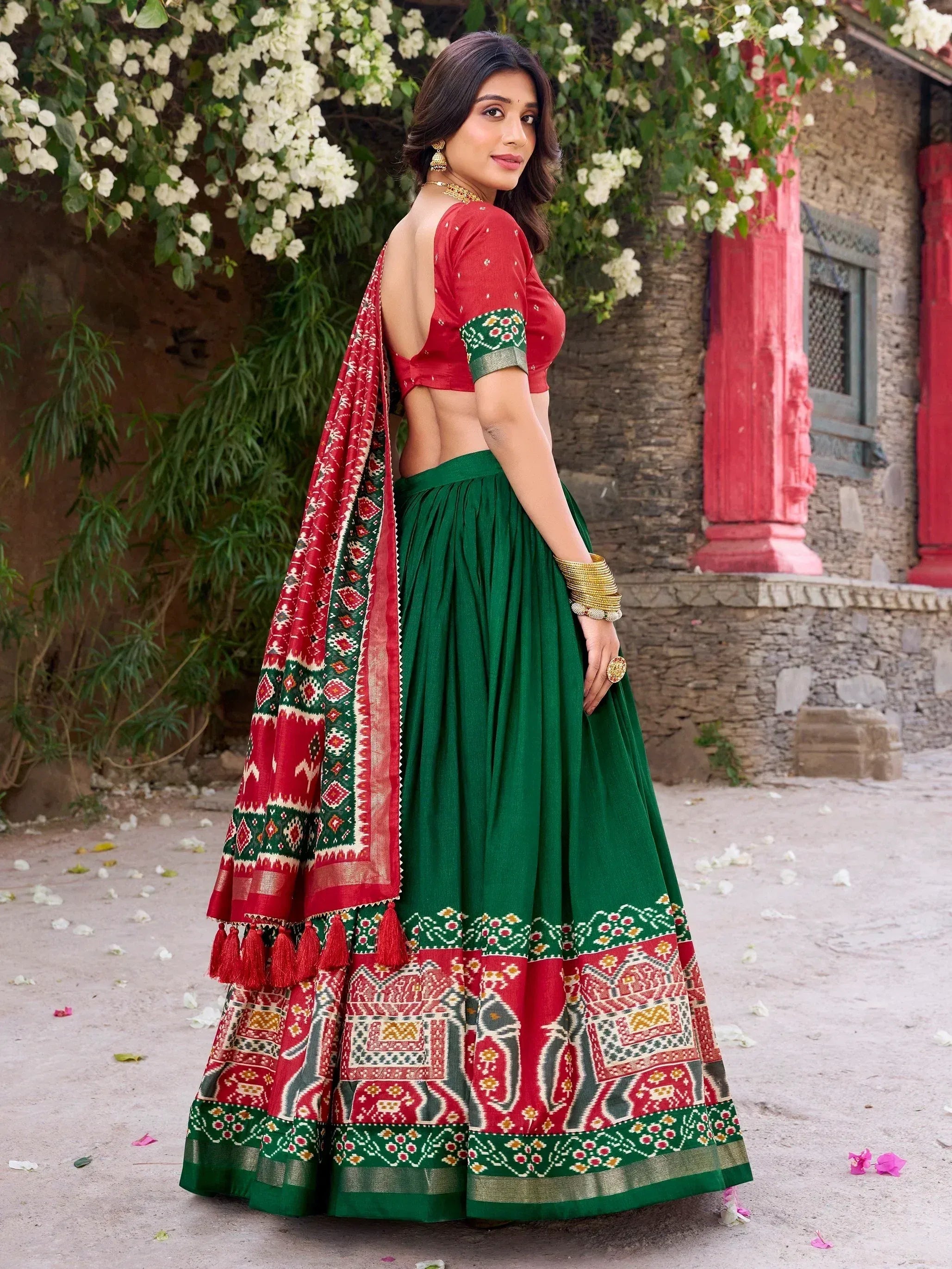 Green and red ethnic lehenga choli with printed dupatta, perfect for Indian weddings and festive occasions