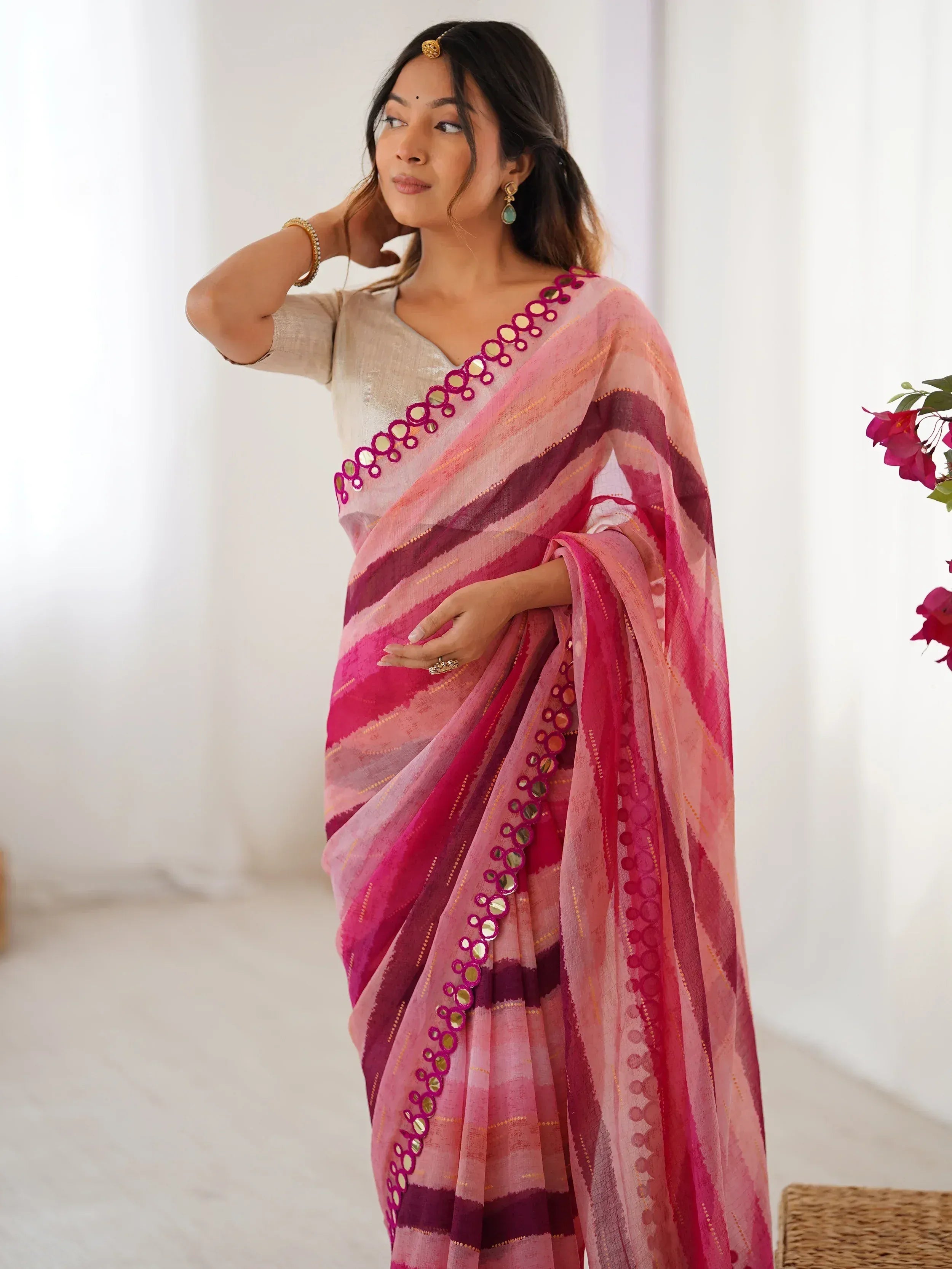Woman in pink striped saree with mirror work, ethnic Indian wear, designer saree style