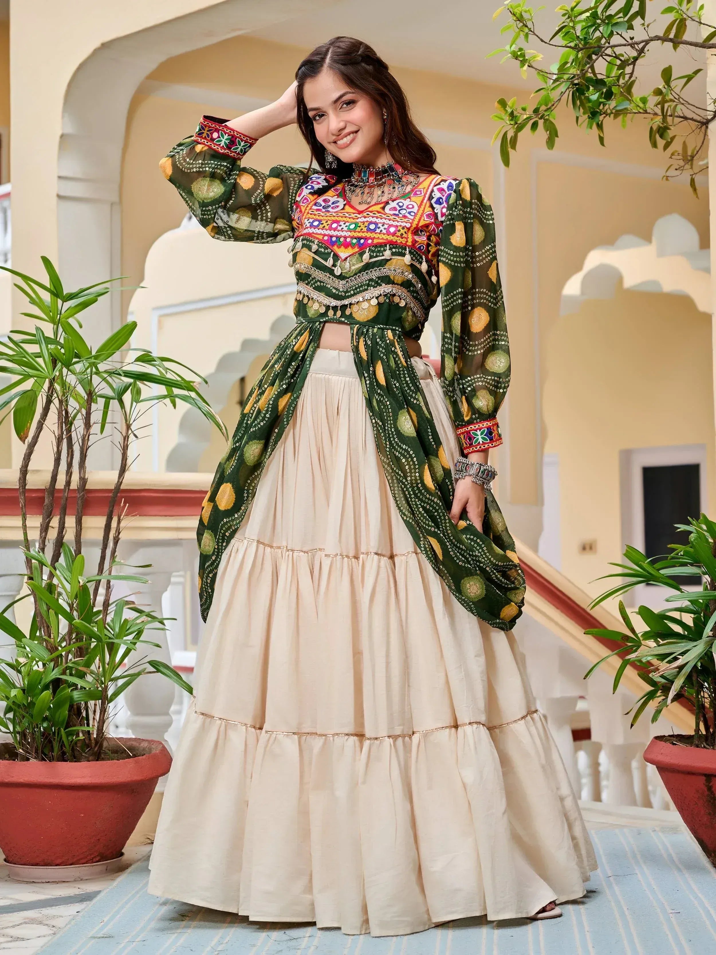 Woman in green embroidered crop top with cream tiered skirt, Indian ethnic wear