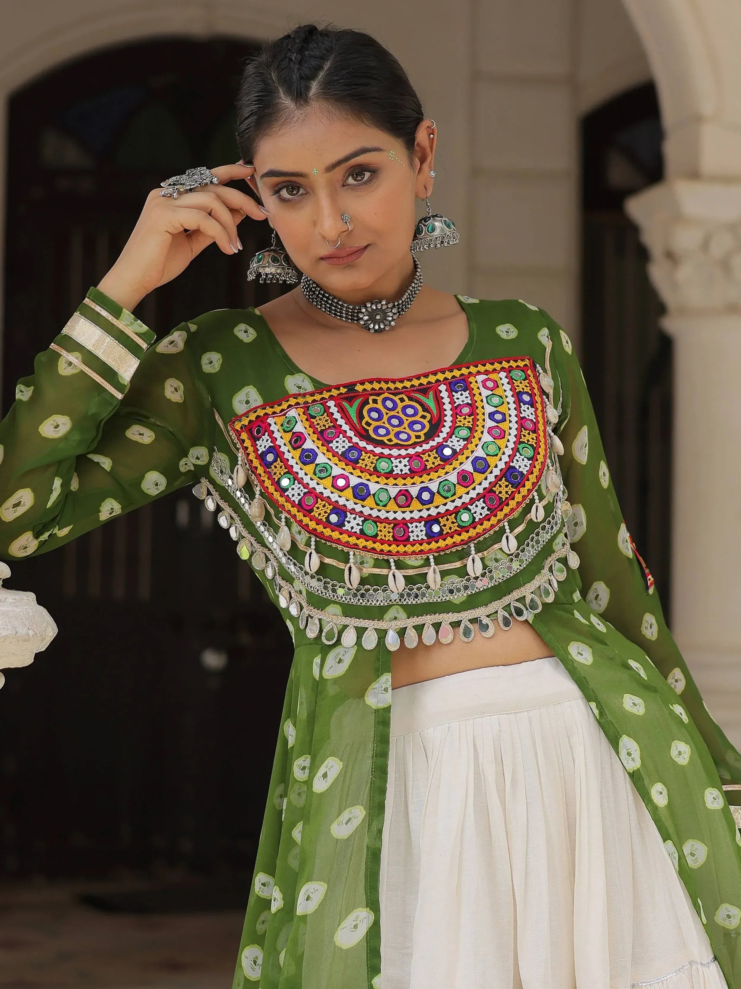 Green embroidered ethnic top with mirror work, paired with white skirt, traditional Indian wear
