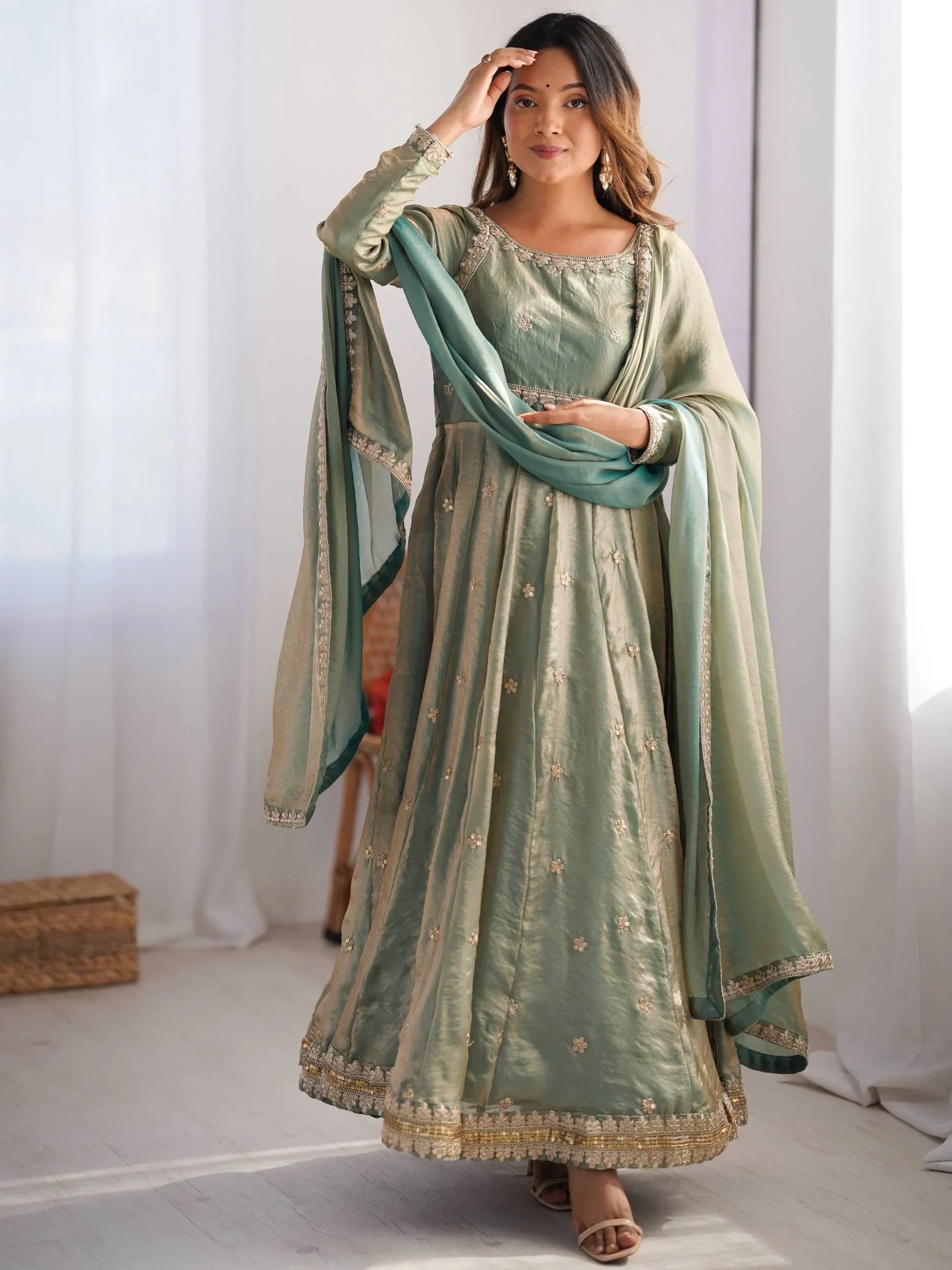 Woman in green embroidered ethnic gown with dupatta, traditional Indian attire