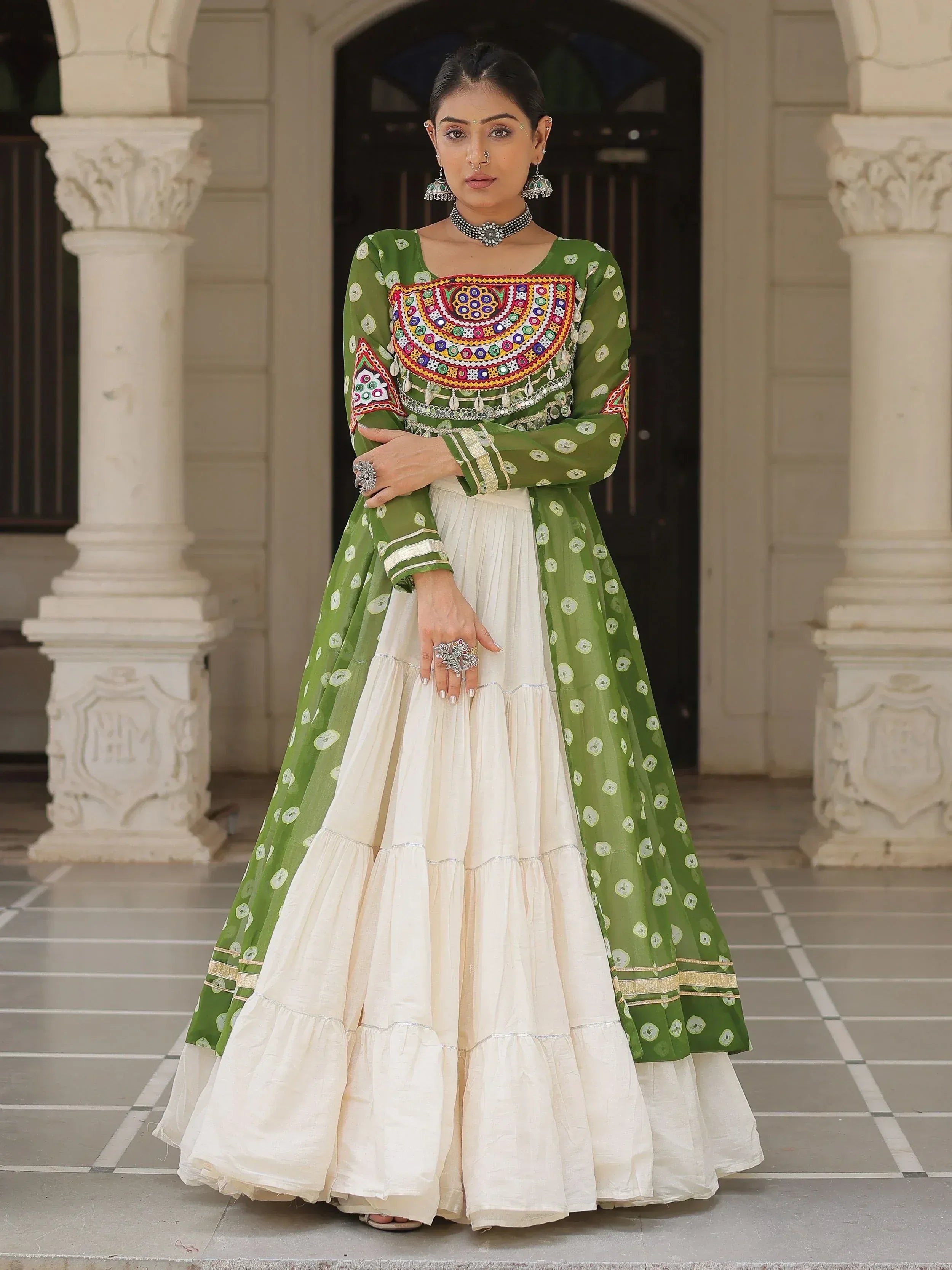 Green and cream ethnic Anarkali suit with mirror work, perfect for Indian weddings and festive occasions.