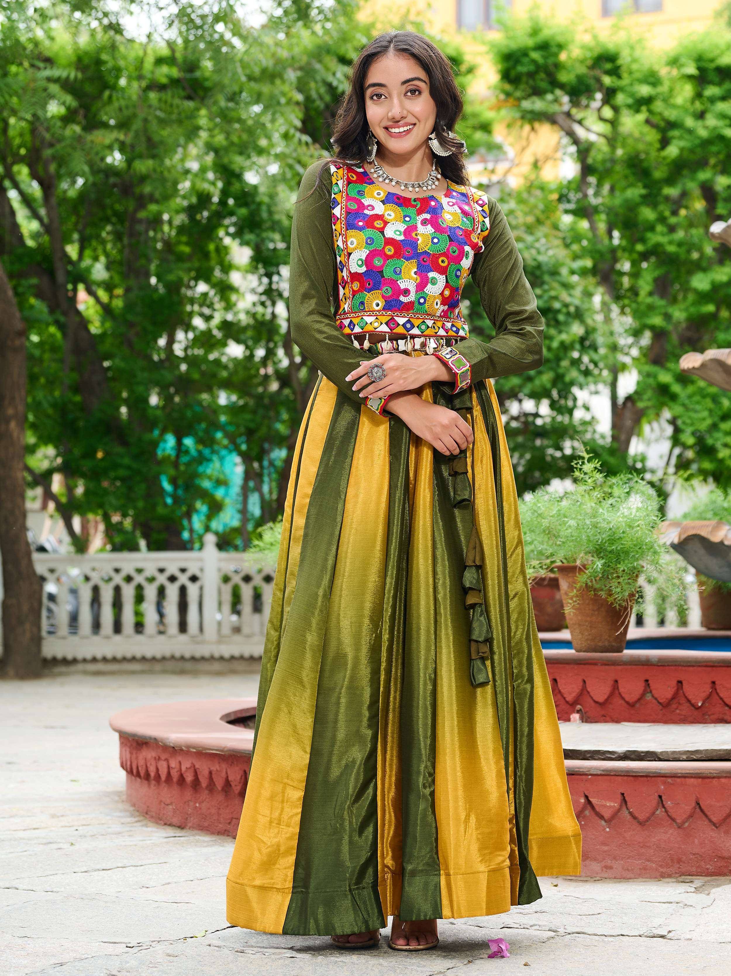 Woman in vibrant green and yellow ethnic anarkali with colorful mirror work, perfect for festive occasions.