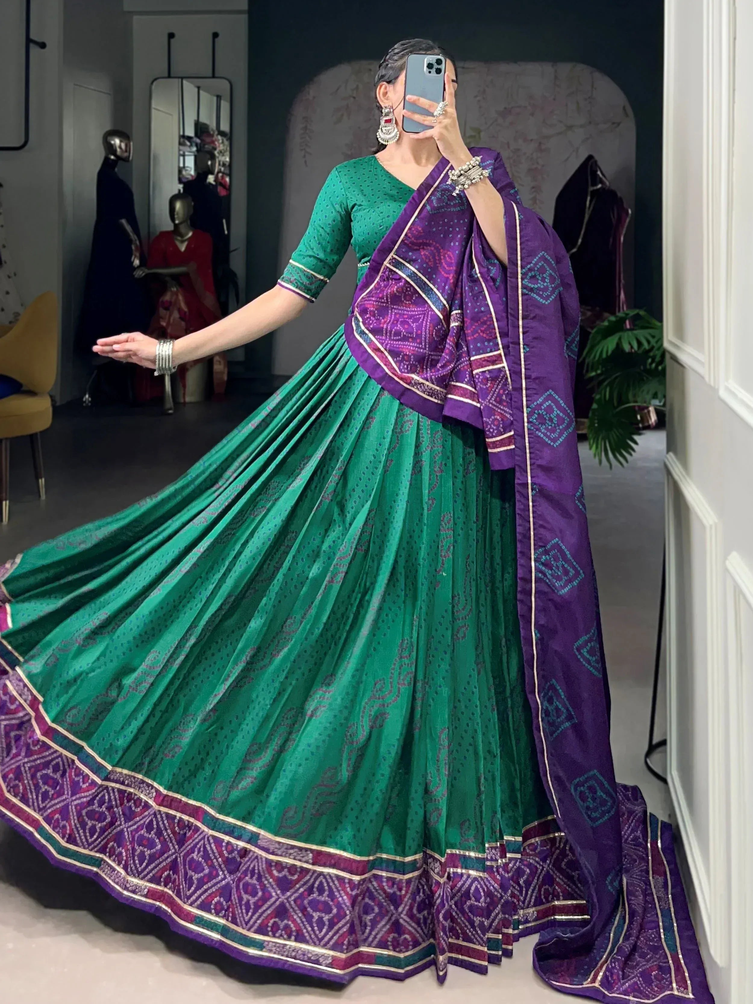 Green and purple designer lehenga choli with intricate patterns, perfect for Indian ethnic wear occasions.