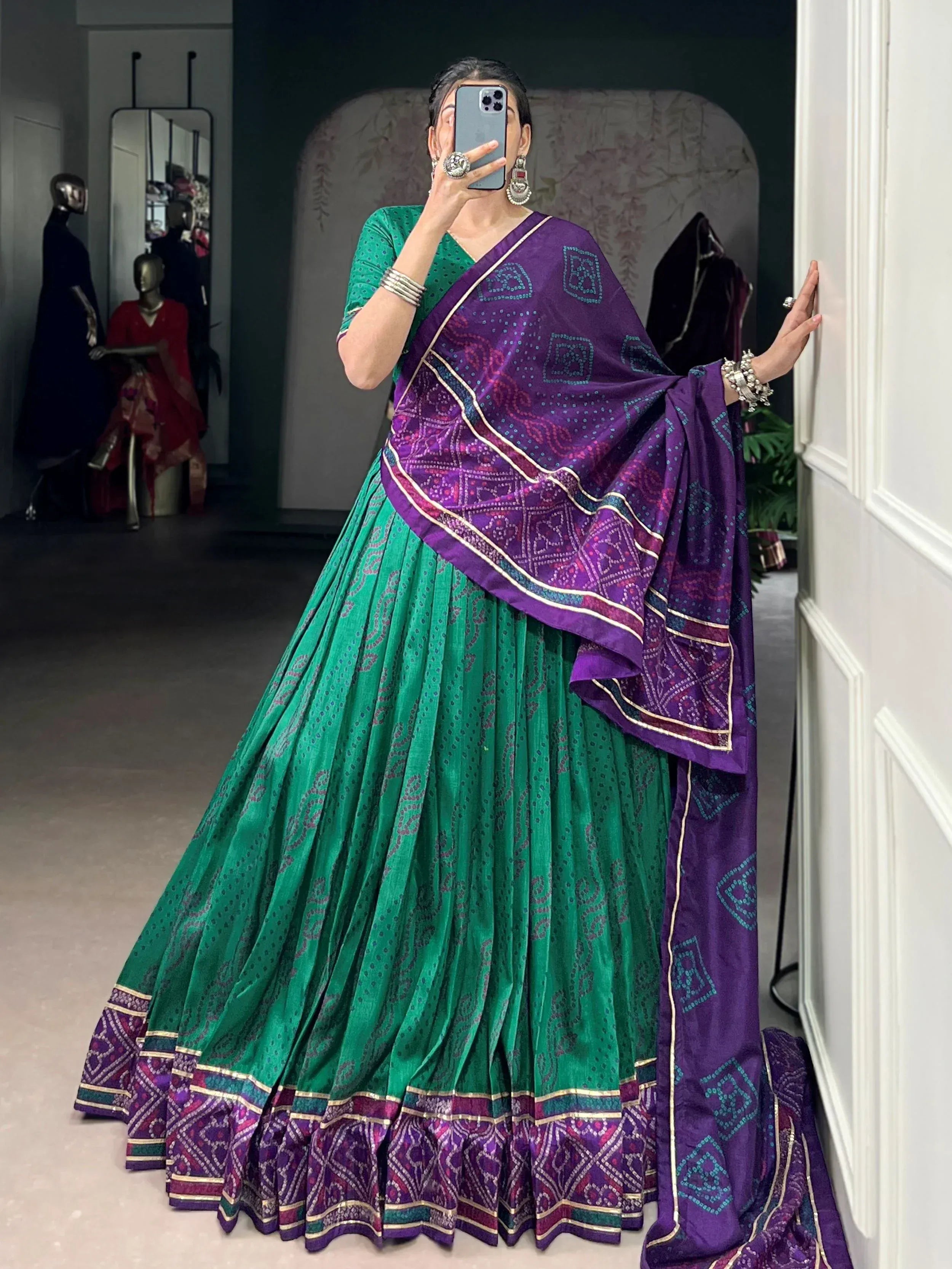 Green and purple ethnic lehenga choli with printed dupatta, perfect for Indian weddings and festive occasions.