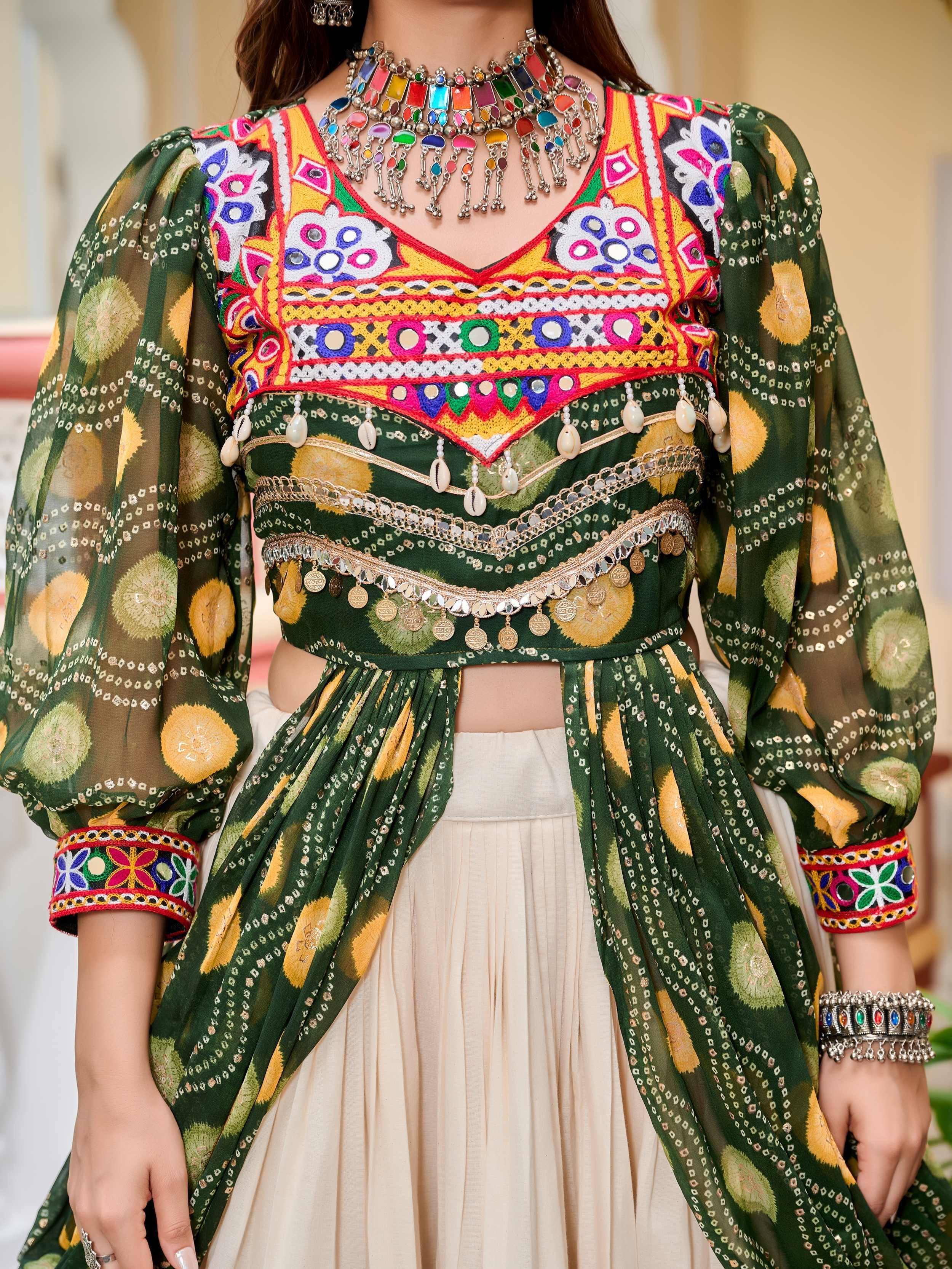 Green embroidered ethnic crop top with mirror work, puff sleeves, and coin detailing, paired with cream skirt