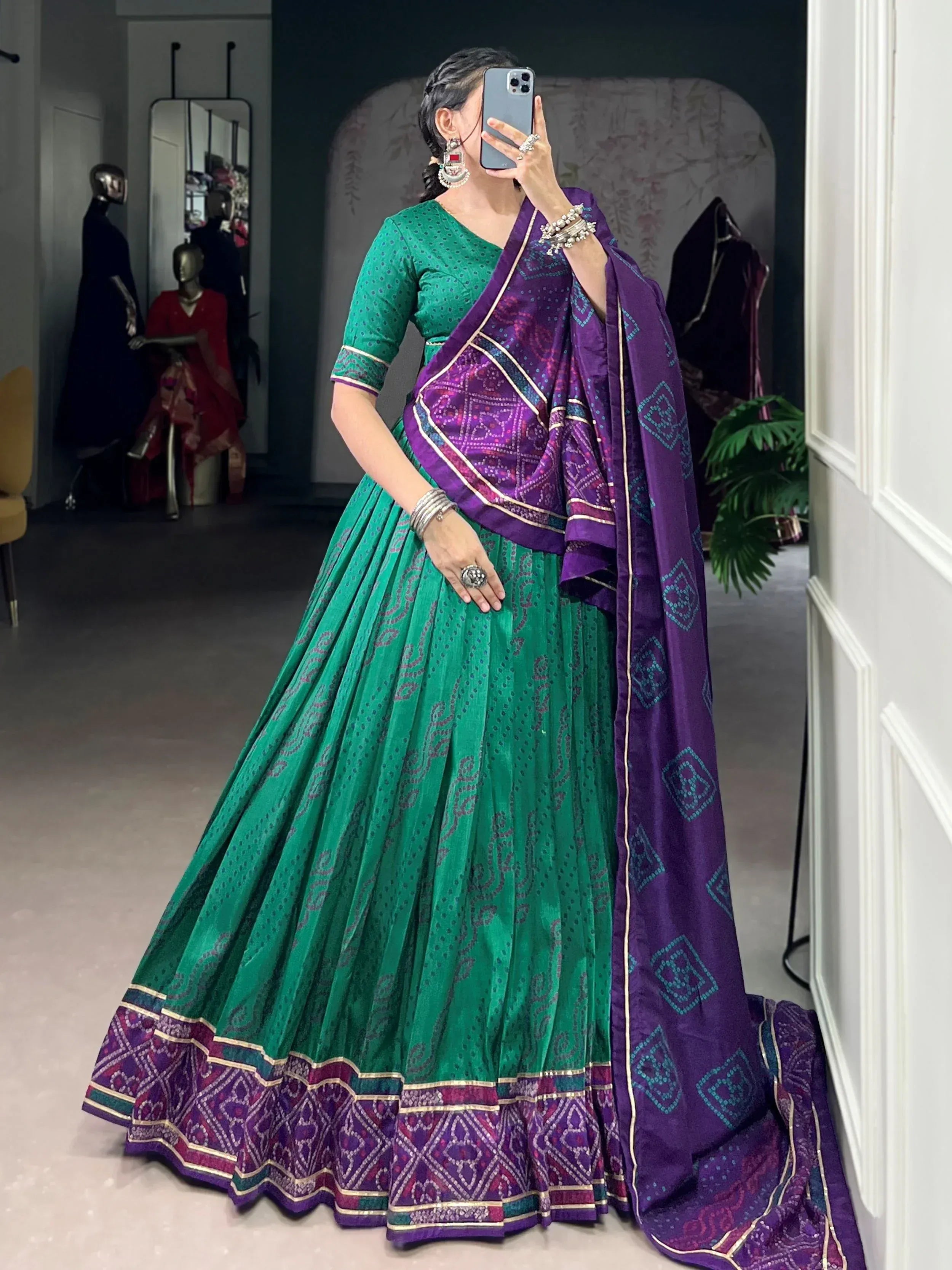 Green and purple designer lehenga choli with intricate patterns, perfect for Indian ethnic wear