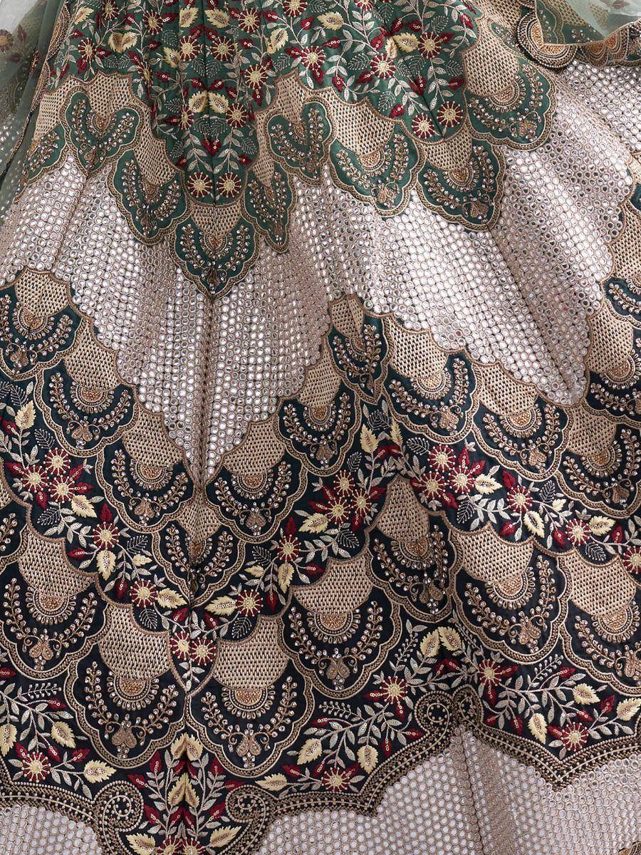 Designer lehenga with intricate floral embroidery and sequin detailing in green, gold, and red tones