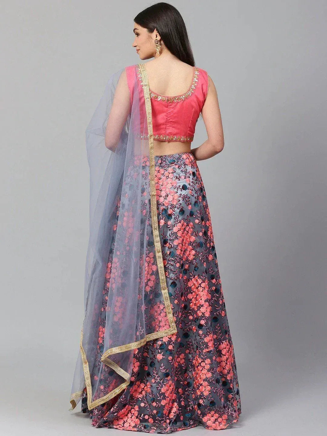 Pink and grey floral lehenga choli with gold trim and sheer dupatta, back view
