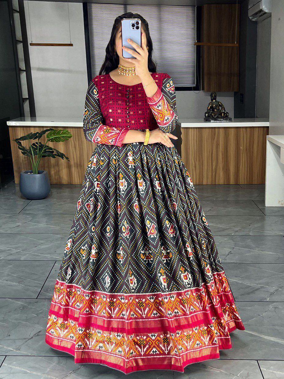 Woman in black and pink ethnic printed gown with full sleeves and flared skirt