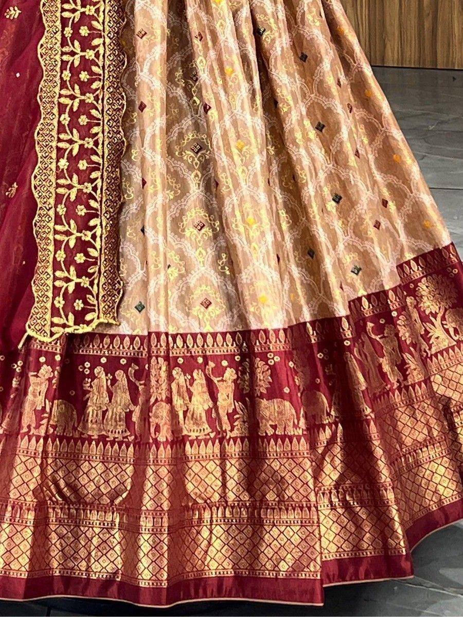 Maroon and gold embroidered lehenga with intricate floral and elephant motifs, perfect for Indian ethnic wear.
