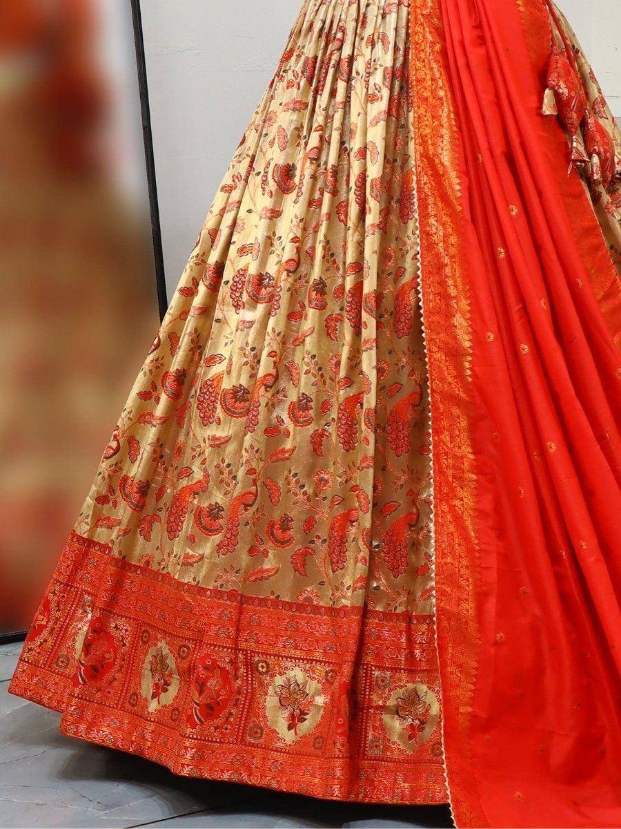 Red and gold printed lehenga choli with intricate paisley border, ethnic Indian wear