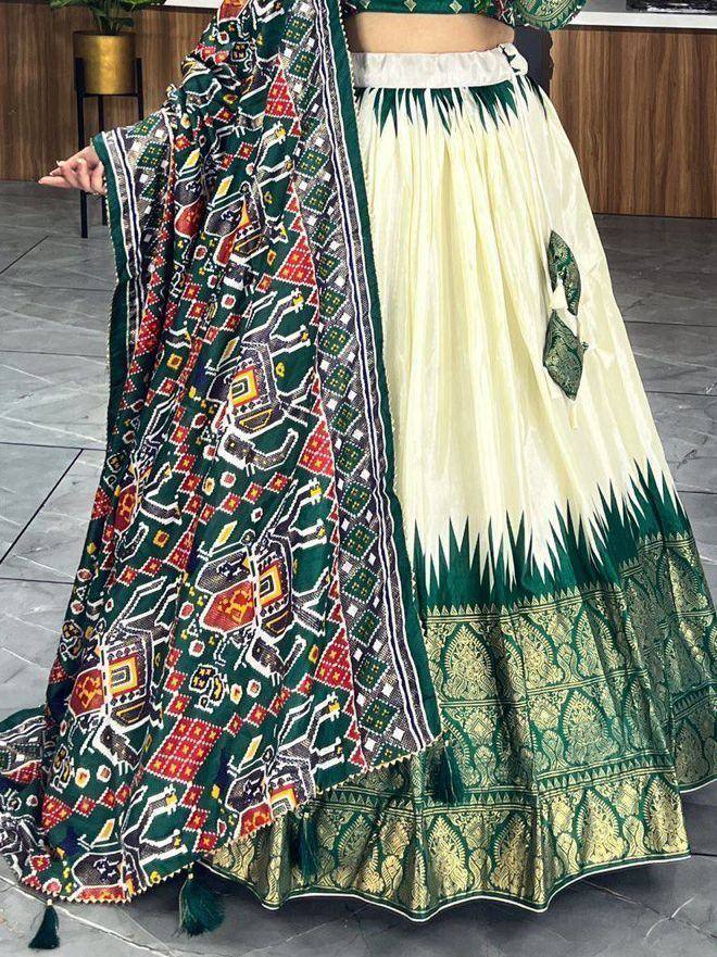 Green and cream printed lehenga choli with ethnic patterns and dupatta, perfect for Indian festive wear.