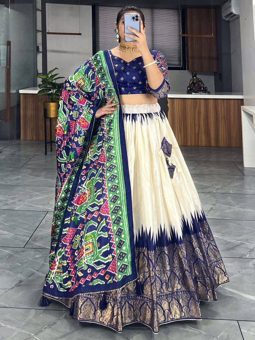 Woman in blue and cream lehenga choli with colorful printed dupatta, ethnic Indian wear