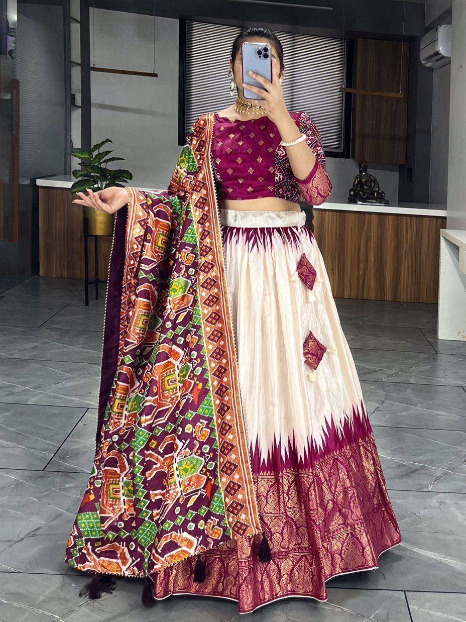 Woman in maroon and cream designer lehenga choli with colorful printed dupatta, ethnic Indian wear
