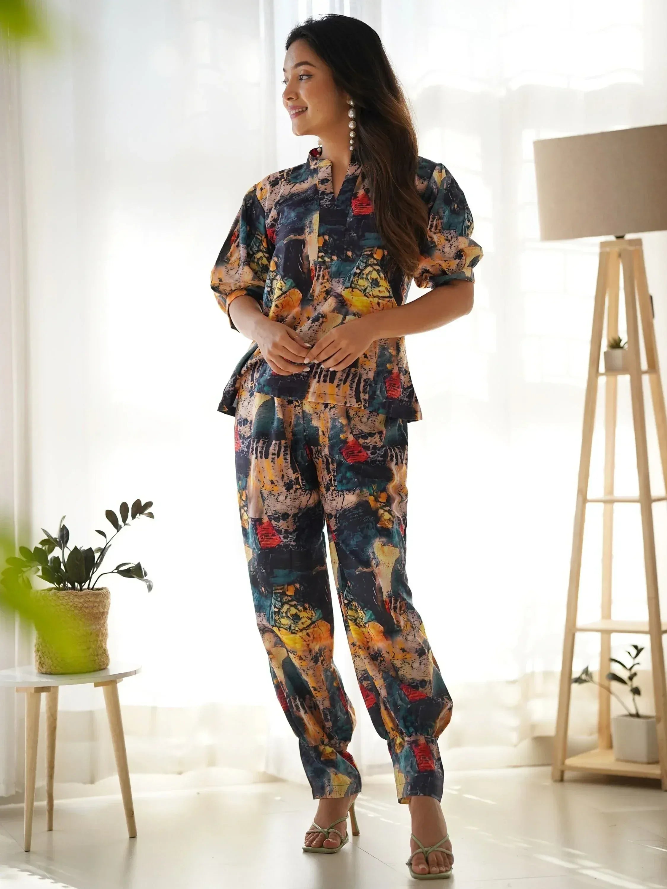 Woman in colorful abstract print ethnic palazzo suit with puff sleeves, perfect for casual wear