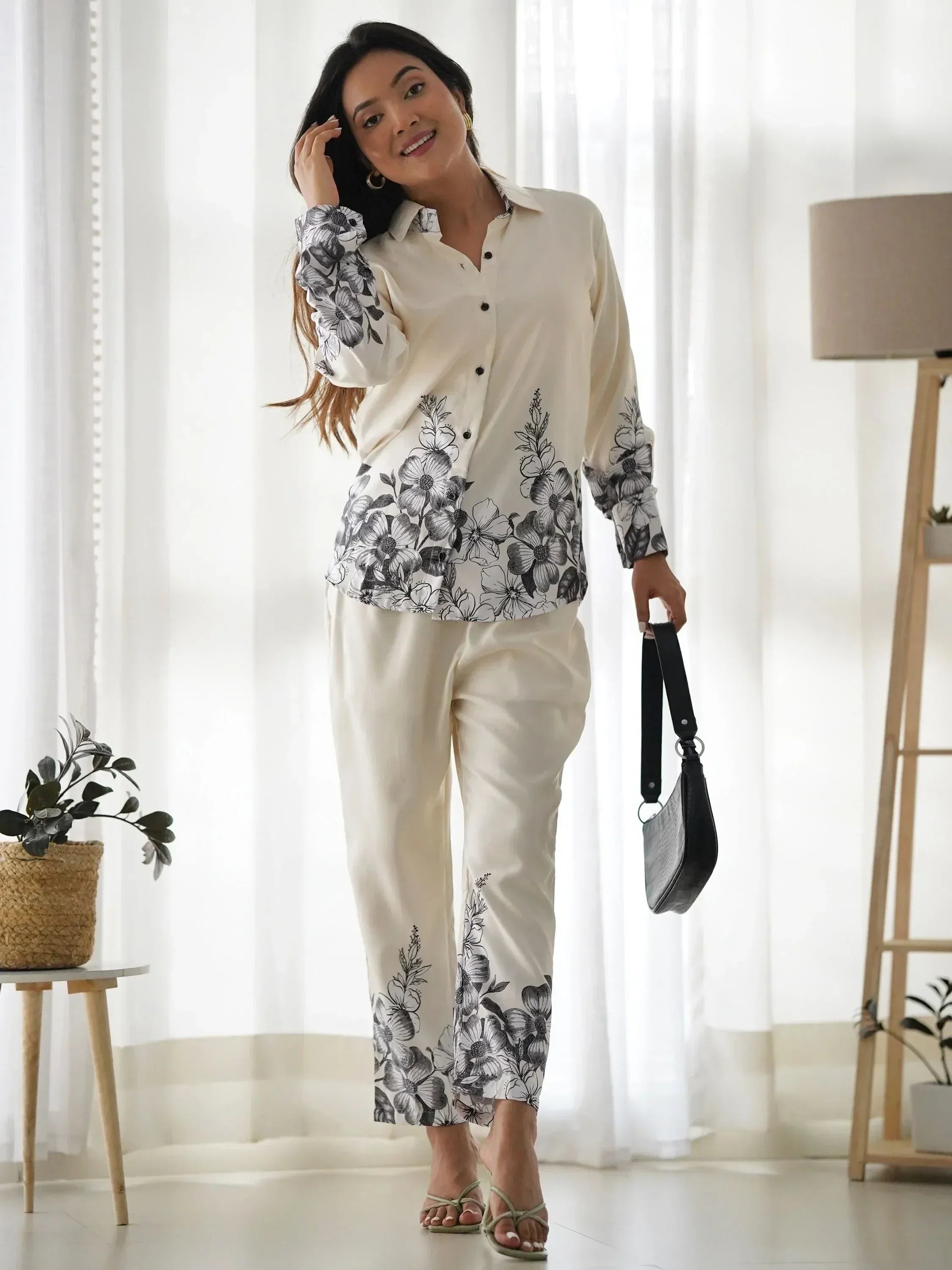 Cream floral print shirt and pants set with black botanical design, styled for casual ethnic wear
