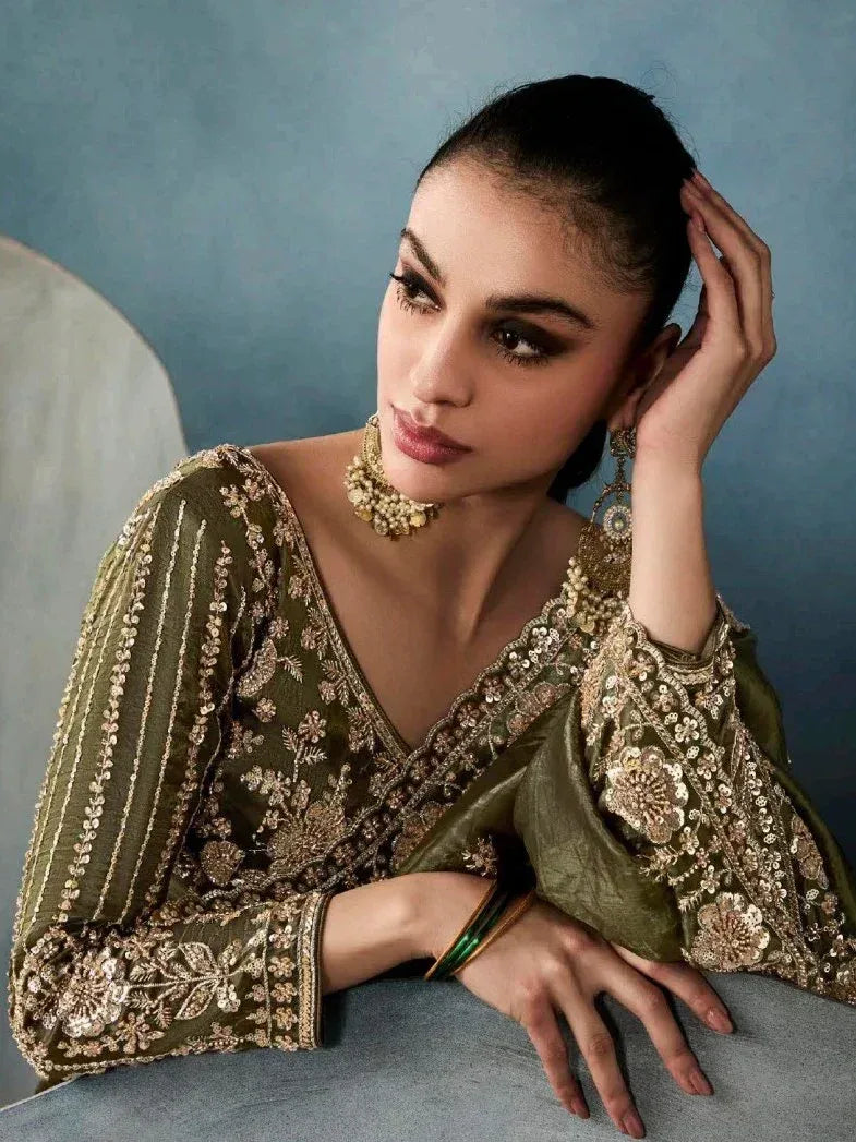 Olive green embroidered ethnic gown with gold floral detailing, perfect for Indian weddings or festive occasions.