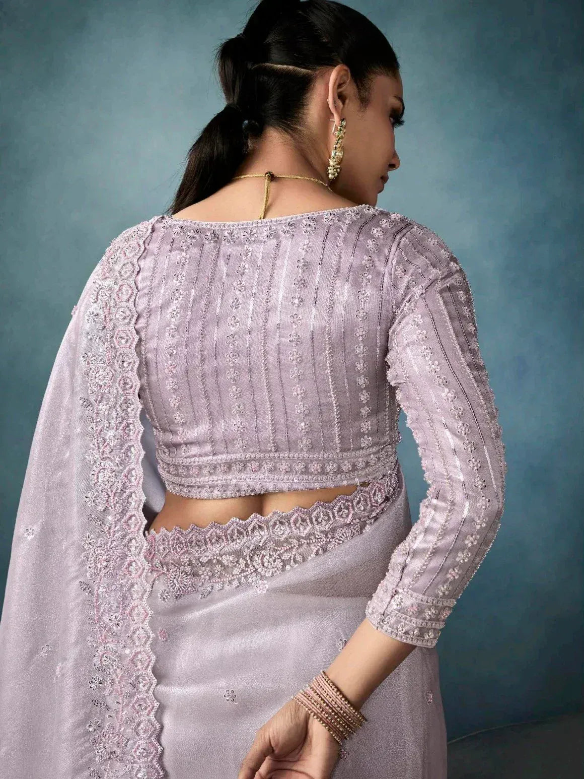 Lavender embroidered saree with detailed back blouse, perfect for Indian ethnic wear occasions.