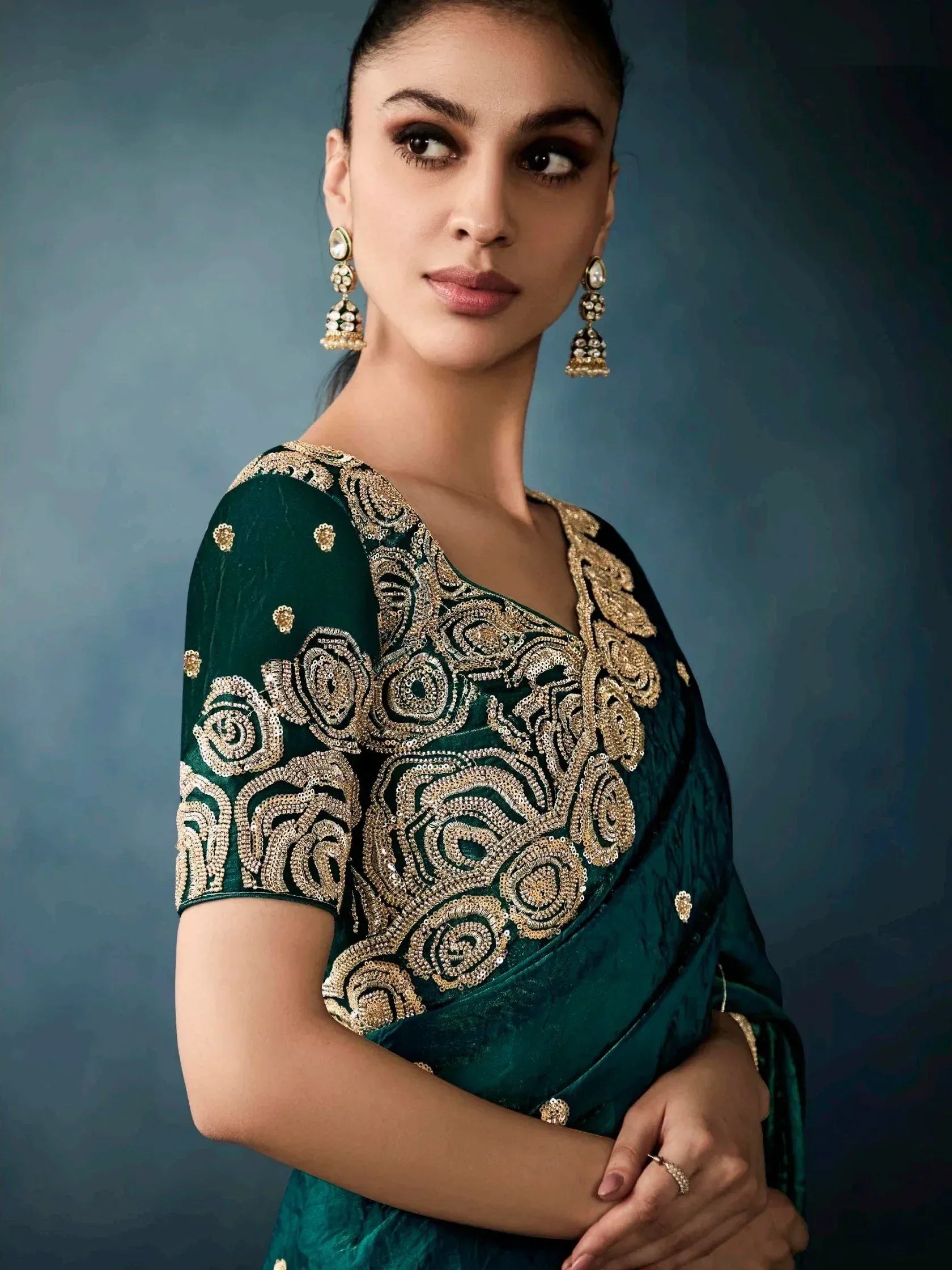 Emerald green velvet saree with gold embroidery, perfect for Indian ethnic wear and festive occasions.