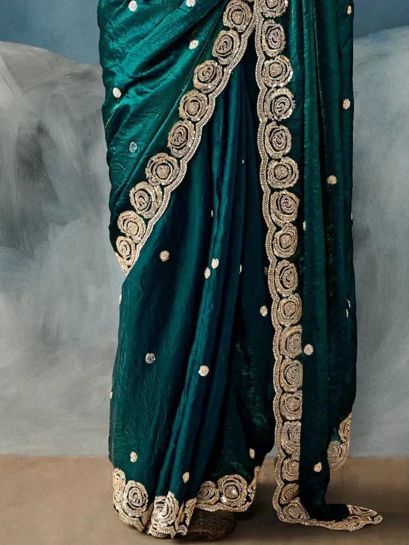 Emerald green designer saree with gold floral embroidery and sequin detailing, perfect for Indian ethnic wear.