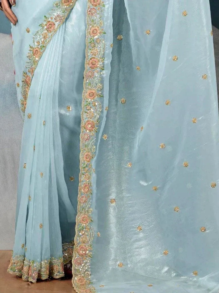 Light blue saree with floral embroidery and gold embellishments, ideal for ethnic occasions
